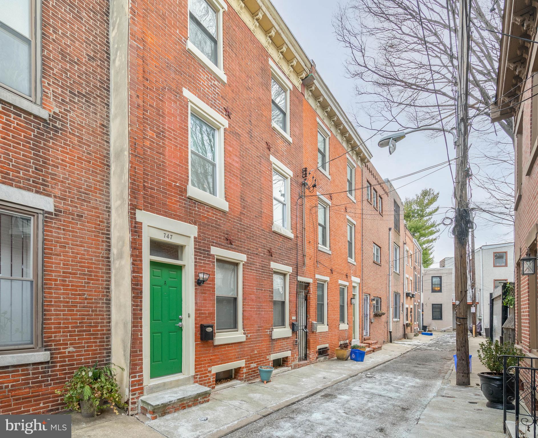 A sought-after location in Queen Village, modern updates, and functional layouts make 747 S Randolph St a prime investment opportunity for an owner-occupant who wants to offset their mortgage or someone looking to grow their rental portfolio. This duplex has a leased 1 bed, 1 bath on the lower levels and a vacant, newly renovated 2 bed 1 bath on the upper levels, both offering private entrances, in-unit laundry, central a/c, and outdoor space. A quiet block leads to this hidden gem's classic red brick exterior. Stepping into unit #A from the street, you'll find an open and airy living room with lots of space to hang out and great natural light from a pair of tall windows. Luxury flooring extends past a sleek full bathroom into the sunlit bedroom. Out back is a shared rear yard, perfect for summer barbecues and laying out with a good book. The lower level features a modern kitchen with shaker cabinetry, stainless steel appliances, including a dishwasher, and space for a dining table. A large storage room with the laundry completes the unit. A secure breezeway from the street leads to unit #B. This apartment also has a bright, open main level with a living room at the front, a laundry closet at the center, and a new eat-in kitchen at the rear. An exposed brick wall adds character throughout, and a serene balcony sits off the rear. Up on the second level, airy bedrooms with double closets sit on opposite ends. At the center is a gorgeous bathroom boasting brass-tone fixtures, an LED mirror, and high-gloss subway tile. Topping off the property is a private roof deck that showcases stunning skyline views. In addition to everything inside, 747 S Randolph St's fantastic location earns a near-perfect Walk Score of 99! Top-rated restaurants, local shops, and popular stores line both E Passyunk Ave and South St nearby. Idyllic Weccacoe Playground is around the corner, plus the surrounding neighborhoods have lots to explore. There's also easy access to public transit, Washington Ave, I-95, and South Jersey. Schedule your tour today! Some photos are from previous listing.