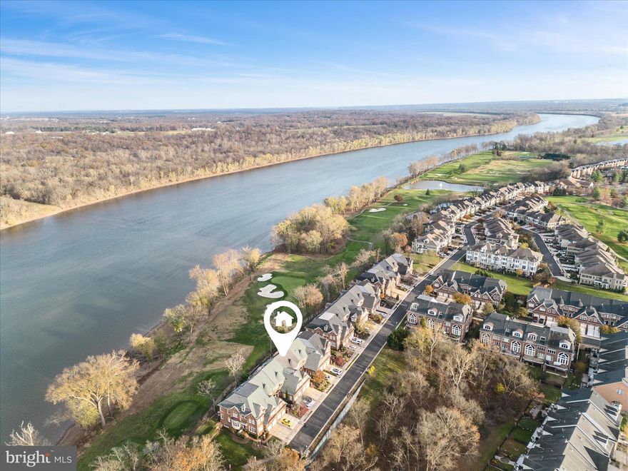 Welcome to this luxury all brick 4-level townhome offering breathtaking views of the Potomac River and the 17th hole of the River Creek Golf Course. This exceptional home boasts multiple balconies, an infinity deck, and a private patio, creating the perfect private and quiet oasis for outdoor living and entertaining. Coming through the front door you can see the Potomac River thru the family room windows. Beautiful hardwood floors flow through the main and upper levels, adding warmth and elegance.  2-story family room with gas fireplace and river views. Gourmet kitchen with granite countertops, island, and breakfast bar, GE Profile stainless steel appliances. The main level features a cozy breakfast area, a formal dining room, and a dramatic curved staircase leading to the primary suite retreat on next level. This spacious suite includes a sitting room, two custom walk-in closets, and a Juliet balcony with unrivaled views. The luxury en-suite bath offers dual vanities, a soaking tub, and a separate shower for a spa-like experience. The third level includes two additional bedrooms, a full bath, and another balcony overlooking the golf course and river. The entertainment-focused lower level features a large bar area and a home theater with a movie screen and projector—perfect for hosting guests. Located in the sought-after River Creek community, this home provides access to exceptional amenities, including golf, tennis, a clubhouse, and walking trails. Don’t miss this rare opportunity to enjoy resort-style living with stunning natural vistas. Schedule your private tour today!