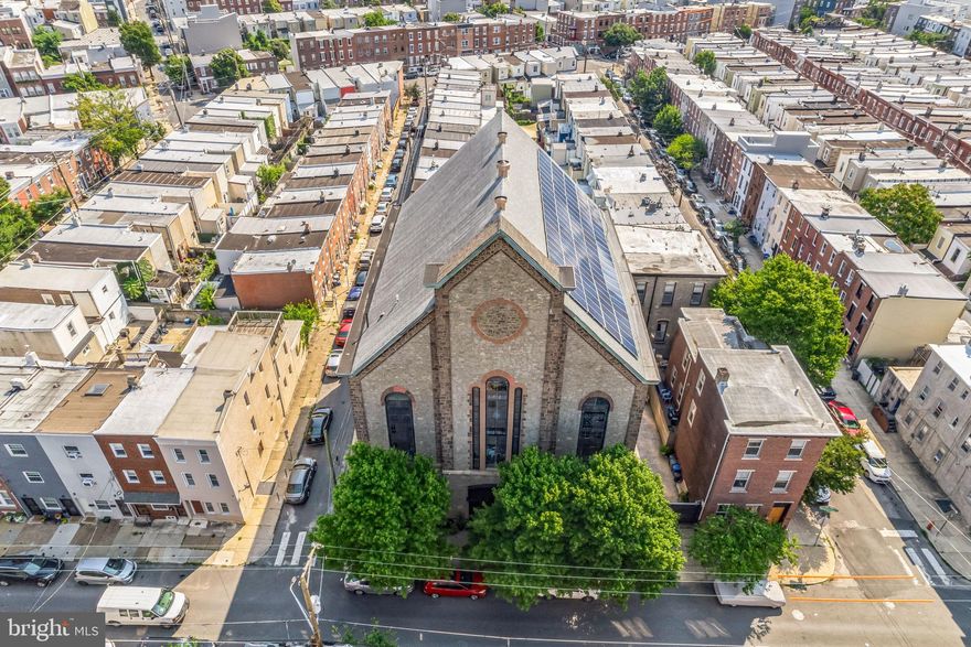 Discover a property that sparks the imagination and offers endless possibilities. This iconic Fishtown building, with its rich history and modern updates, is a true gem. Constructed between 1845 and 1860 during the Civil War, it was founded by Anthony Atwood S.S. and Robert H. Pattison as Siloam Methodist Church. Standing over 60 feet tall, the solid stone structure boasts 128 solar panels on the roof, installed in 2013. These panels generate 34,000-36,000 kilowatts annually, covering most of the building's electric bill. The solar system includes four inverters in the basement and primarily powers the main unit. The exterior features a charming courtyard with stamped concrete paving, a 22-foot electric door, 2-3 parking spaces, and an 8-foot white cedar fence providing security and privacy.

The interior is equally impressive. The stunning entrance features grand mahogany staircases leading to the upper floors. The first floor includes a photography studio, kitchen, lounge area, makeup corner, and full bathroom in a wide-open loft space. The sanctuary, with a 35-foot ceiling and stained glass windows, is vibrant and full of potential, though still unfinished. The third floor, the owner's unit, combines old-world charm with modern design, including salvaged doors, a unique three-sink vanity, and a stained glass shower stall. Two large bedrooms and a custom-built dressing room complete the space. The full basement offers 3,500 square feet with 10-foot ceilings, a kitchenette, two bathrooms, and ample storage.

The property also includes two additional loft apartments, each with separate electric and gas meters, large kitchens, bathrooms, shared laundry, and private entrances. Units rent for $2,000 and $2,500 monthly, with the main studio available for $1,400 daily. Recent renovations include a new roof (2023), new downspouts (2022), and mechanical upgrades. The sanctuary has been demoed and plastered, with the balcony converted into bedrooms, a bathroom, laundry room, and dressing room. Six HVAC units heat and cool the various spaces, ensuring comfort throughout.

The stellar location offers easy access to local restaurants, bars, and shopping. Local favorites like Green Eggs Cafe, Riverwards Produce, Suraya, La Colombe, LMNO and so many more. Not to mention, it's located in The Adaire School catchment, easy 1-95 access to Center City Philly, NJ and NYC. Don’t miss this unique opportunity to own a piece of Philadelphia's history!