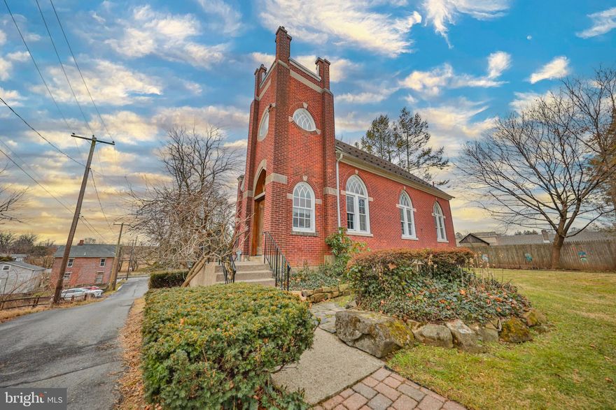 A distinguished landmark in the Lehigh Valley that once served as a house of worship, now a one-of-a-kind prized property, awaits the discerning buyer to appreciate the love that has been poured into this converted church home. Embellished with stunning architectural detail throughout dating from the early 1900's. Marvel at the magnificent entry and its ornate steeple. Appreciate the elegant oversized stained glass windows, refinished hardwood, exposed brick, and many seamless blends of old and new. Dramatic 20 foot ceilings with exposed wood beams decorate the grand gathering space, perfect for those who love to entertain, dine and mingle, or wish to downsize without sacrificing space. The kitchen was renovated 2 years ago. The versatile middle room can be a first floor bedroom, lounge, or study, with a pull down door for utmost privacy and updated full bath is adjacent. Brand new carpet expands throughout the vast loft space currently housing the primary bedroom and en-suite. Generously proportioned spaces continue to the partially finished basement providing a comfortable space to retreat, featuring an outside entrance, updated full bath and plumbed for a kitchenette. The exterior park-like setting is reminiscent of a secluded getaway. Geo thermal Heat, Central Air, Dual carports, parking pad, and one car garage is bonus. Centrally located & only 1.5 hrs to NYC, 1hr 15 to Philly. Beautifully maintained, this stately historic gem is indeed an exquisite living experience.