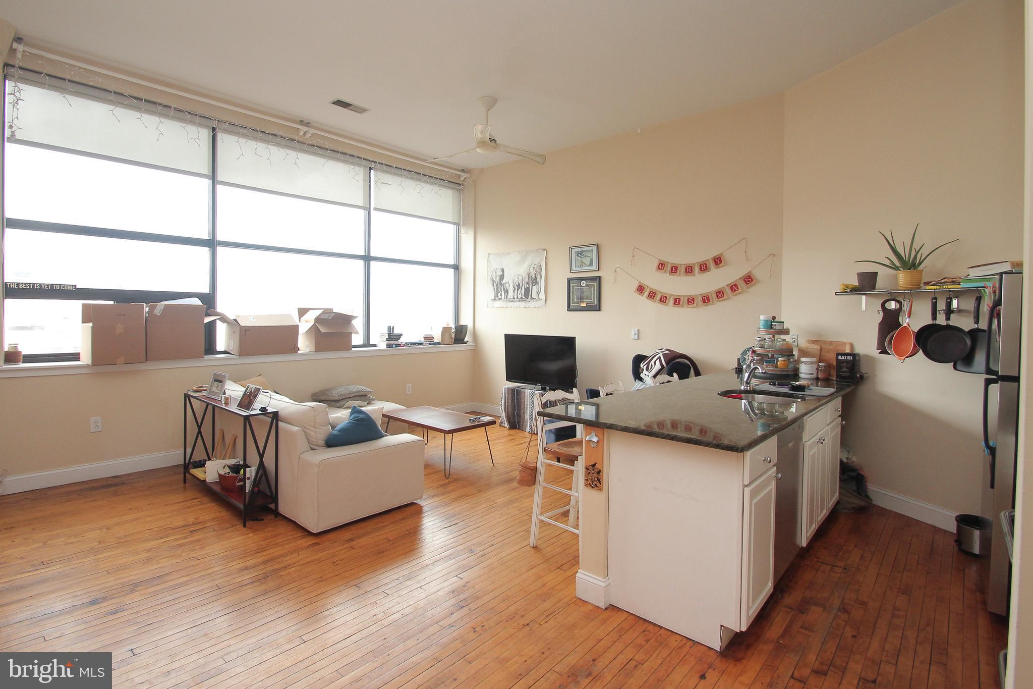 Spacious, industrial style 1 bedroom apartment with amazing light and 6th floor view of Center City.  Central Air and common laundry on the 6th floor.   Stretch into the 14 foot ceilings and open living/dining area.  Modern kitchen with dishwasher and 10 feet of granite breakfast nook that fits 4 stools.   Down the hall, across the original wood floors, the separate bedroom easily fits a queen-sized bed and large bathroom boasts a double vanity.  This is a very clean, well kept condo building with keypad entry, elevator and front door camera. One pet considered with a refundable $250 pet deposit.  Laundry (e-card) and trash room just down the hall on the 6th floor.  Apartment is all electric with average yearly monthly bill of $105.  Landlord is local and extremely responsive.  Video tour available upon request.