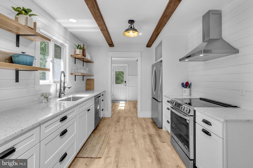 Step into this charming 3-bedroom, 2-bath rambler that feels like it was styled by Joanna Gaines herself! Set on over 4.8 acres, this beautifully updated home blends modern farmhouse charm with tranquility. The newly renovated kitchen is a showstopper—featuring gorgeous granite countertops, soft-close cabinets, stainless steel appliances, shiplap walls, open shelving, and modern light fixtures. Enjoy cozy evenings in the spacious family room with a wood-burning fireplace and a large bay window that frames the stunning front yard. The home is filled with stylish touches from top to bottom, including updated flooring and modern finishes throughout. A deck just off the kitchen offers the perfect spot for morning coffee or evening gatherings, and the partially finished basement provides flexible space for a home office, gym, or playroom. Located just 33 miles from the U.S. Capitol and 25 miles from Joint Base Andrews, this is country living with a commuter-friendly location!