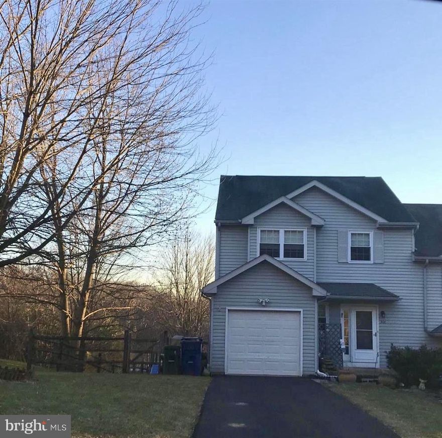 End-unit townhome with fenced in yard and your own DRIVEWAY!  Featuring 3 bedrooms, 1.5 baths, and a one-car garage. The main level offers a welcoming foyer, a spacious living room with TONS of sunlight overlooking private, wooded setting.  An open dining area. The eat-in kitchen provides ample cabinet and counter space and an Island with seating and STORAGE!  A conveniently located half bath on the main level as well. The upper level includes a primary bedroom with ceiling fan and generous closet space, two additional bedrooms, and a full hall bath. The lower level provides a family room with a wet bar! Separate storage rooms along with a dedicated laundry closet and walk-out access to the rear yard. There is also driveway parking, and an end-unit location. Convenient to major routes, shopping, and dining.