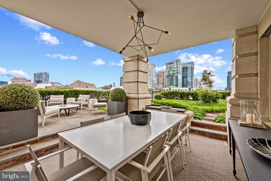 Experience waterfront luxury at its finest in this exceptional 3-bedroom, 2.5-bath, 2600+ square foot garden-level residence at The Ritz-Carlton Residences in Baltimore. Offering multiple patios and expansive outdoor living spaces, this home provides an unparalleled connection to the Inner Harbor's serene beauty. This corner residence with ten-foot ceilings and expansive windows in every room is perfectly designed with well-proportioned living spaces that offer panoramic views of the water from every angle.  The newly built gourmet kitchen with gorgeous cabinetry, counters, flooring, and appliances has a center island with bar seating and overlooks the open concept living and dining areas. The living room has direct patio access and is centered around a gas fireplace with a bar area and stunning custom shelving.  The dining area is fit for a lavish dinner party or a couple of two enjoying the evening sky.  A spacious primary suite features incredible views, ample closet and storage space, and a luxurious bathroom with two vanities, a jacuzzi tub, and a walk-in shower. The second bedroom is separated from the primary and includes a walk-in closet with access to a hall bathroom with a walk-in shower. The versatile third bedroom, currently used as an office with a beautiful built-in desk and shelving, offers flexibility to suit your lifestyle. Custom cabinetry and closet systems throughout the residence, a temperature-controlled wine closet, and newly installed hardwood flooring throughout complete this incredible residence.  Two deeded parking spaces and a separate storage area are included. Embrace the opportunity to live in one of Baltimore's most prestigious addresses, where luxury meets convenience and every day feels like a retreat.  Unwind on your private patio before stepping directly onto the Baltimore Promenade to hop on the water taxi or take a scenic stroll. The building’s world-class amenities include 24/7 concierge and security, valet parking, a doorman, porter service, pristine gardens, an indoor pool, a fitness center, a community theater, six guest suites, and multiple elegant event spaces. Minutes away from Baltimore’s vibrant arts district, as well as Ravens and Orioles games and with convenient access to BWI, I-95 South, and Penn Station, this residence provides the perfect blend of luxury, comfort, and accessibility. Discover waterfront living at its finest at The Ritz-Carlton Residences. Schedule your private showing today