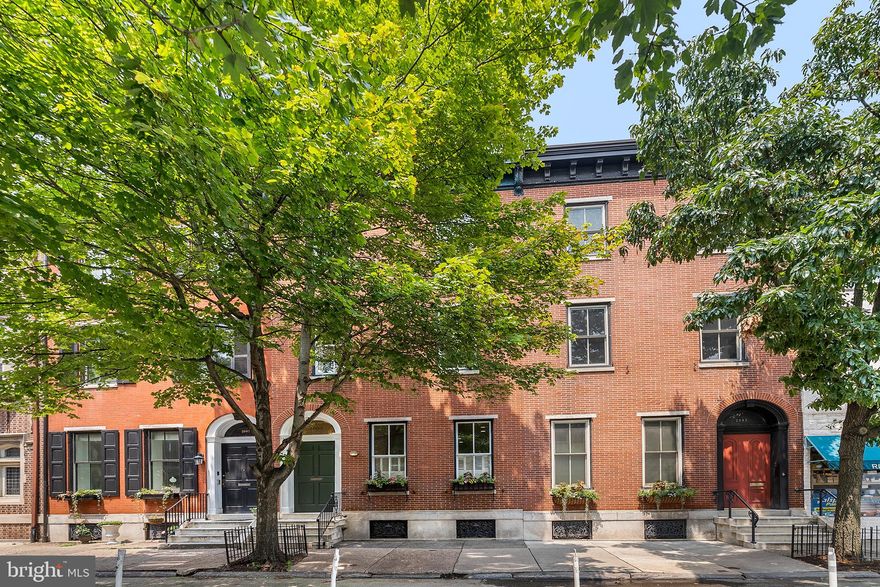 Right in the middle of the leafy Rittenhouse Square neighborhood and a two minute walk to Rittenhouse Square  is this large and yet not overwhelming home. The tiled entry foyer with double doors opens to a hallway and the first floor of this elegant home.  The first level features a casual seating area  and dining room, with high ceilings, fireplace (never used)  and  wood floors and recessed lighting.  There is a full bathroom on this level and an eat in kitchen with sliding doors leading to a convenient side yard which is a perfect spot for grilling.  Behind the kitchen is your private TWO CAR GARAGE.  The second level of this home is a most dramatic living room with a fireplace (owner has never used) , and a bedroom with doors leading out to a large terrace.  There is a full bathroom on this floor as well as the laundry area.  The upper level features a third bedroom  (can also be a den/office or playroom) with a door leading to an additional deck, and the primary bedroom in the front of this home with a large walk in closet and full bathroom with a double sink and a stall shower. This excellent family home has a mid-century modern feel to it and the location is top notch.