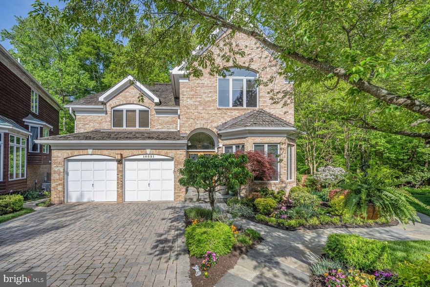 Nestled in one of Bethesda's most convenient neighborhoods, this contemporary-style home offers unparalleled accessibility, situated less than a mile from the Metro, Wildwood Shopping Center, Fleming Park, The Bethesda Trolley Trail, and more.

The home's open floor plan is accentuated by oversized windows and high ceilings, allowing abundant natural light to fill the space. Step through custom double entry doors into a welcoming foyer adorned with a marble floor, setting the tone for the elegance throughout.

The formal living and dining rooms provide an ideal setting for entertaining guests. The kitchen, with its bright white cabinetry, features a central island and ample room for a dining table, seamlessly connecting to a cozy family room complete with custom built-ins and a fireplace.

Step outside to enjoy the three-level IPE Brazilian hardwood deck, which offers stunning views of mature trees and a meticulously landscaped yard with in ground irrigation system. The garden boasts lush grass, perennial plants, vibrant flowers, and a charming water feature, creating a serene outdoor oasis. The backyard is fully enclosed with a cedar fence.

The upper level hosts a grand primary suite with a vaulted ceiling and custom built-ins. Two expansive walk-in closets offer generous storage for clothing and shoes. Two secondary bedrooms share a convenient buddy bath, ensuring comfort and privacy.

A versatile fourth bedroom is designed as an office, featuring a built-in desk, floor-to-ceiling bookshelves, a walk-in closet, and an en suite full bath. This room, with its vaulted ceiling and large windows overlooking the front of the house, is a bright, sunny space perfect for working from home.

The walkout lower level, boasting extra high ceilings, defies typical basement expectations. It includes a spacious recreation room with a gas fireplace, along with an additional bedroom and full bath, ideal for guests.

For hobbyists and creatives, the magnificent workshop is a must-see, perfect for woodwork, crafting, sewing, painting, or other artistic endeavors.

The home also includes a two-car garage, enhanced with a finished floor, shelving, and storage. A paver driver adds to the curb appeal. Located on a peaceful cul-de-sac with no through traffic, this home offers both privacy and convenience.