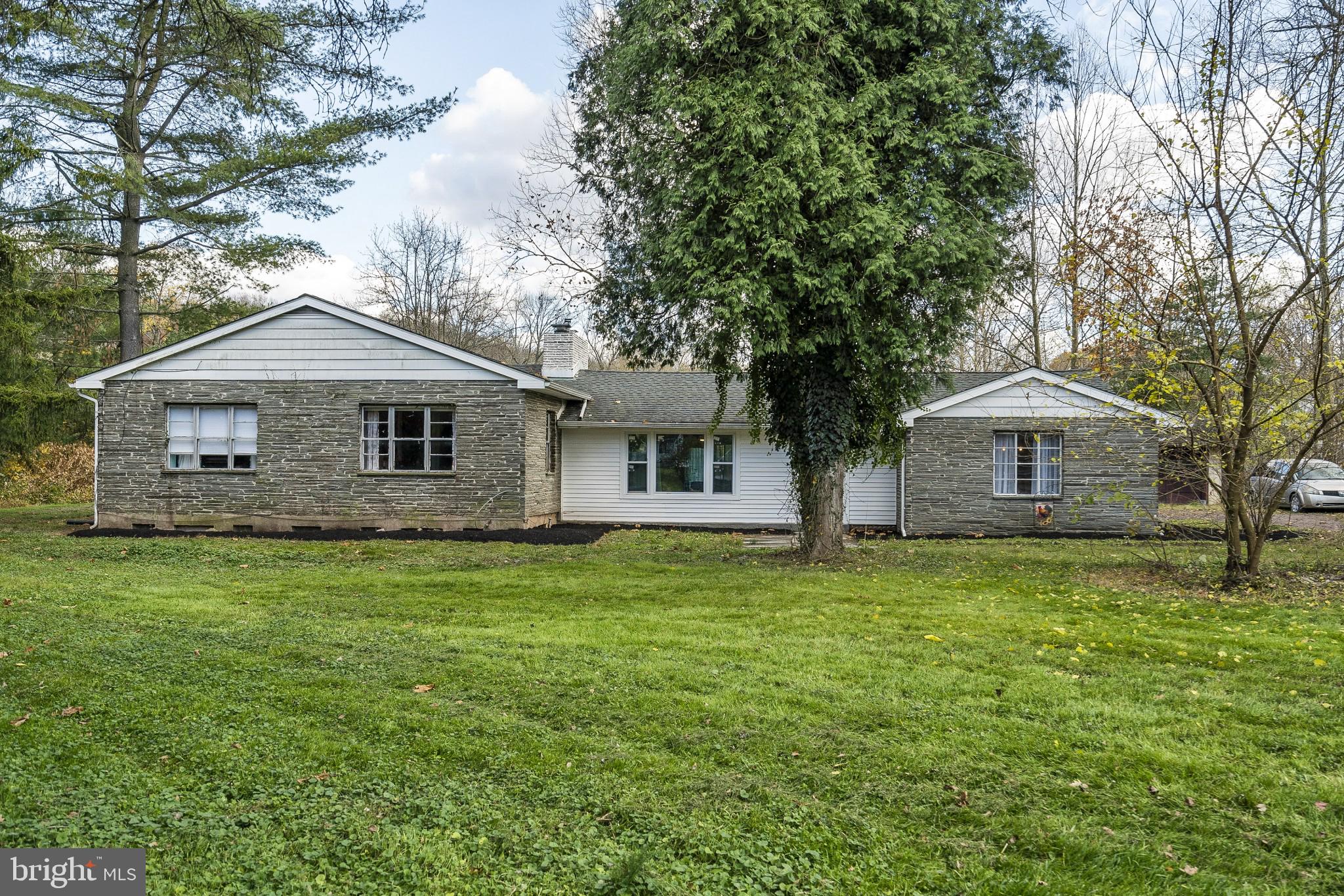 Paradise Found!!! Set amid a mountainous backdrop, 5 Spring Mount Road is a captivating 4+ acre spread with scenic water views, historic ties to the past and unparalleled beauty.  Impervious improvements include a renovated 2559-square foot stone Ranch dwelling and a detached oversized 4-car garage with workshop.   Inside you will find a modernized open concept layout, dark hardwood flooring throughout, renovated kitchen and bathrooms and spacious room dimensions that are sure to impress.  Step up to the private bedroom wing which includes the master suite with private outside access, three generously-sized secondary bedrooms with a sliding barn door and an oversized bathroom with new floor-to-ceiling ceramic tile accents.  Large picture windows allow natural light to fill the interior space and invite the beckoning calls of your new outdoor oasis.  Enjoy breathtaking seasonal views of Spring Mountain from your back patio; take a morning/afternoon/evening stroll through the grounds and explore the historic remnants of railroad bridges and tunnels; or spend a summer afternoon picking strawberries, raspberries or fruit from the maturing trees right in your own backyard.  All paths lead to the creek and more fun and adventures than you can imagine.  Launch your kayaks and canoes from multiple private creek access points and spend the day taking in nature on perhaps the best fishing hole along the Perkiomen Creek.  Or continue downstream on a meandering journey that will take you back in time as you pass under historic stone and railroad bridges, float by old grist and grain mill structures from the 1700-1800s or imagine George Washington's Army who camped along the banks at Pennypacker Mills in 1777.  You can make this dream a reality and call it your next home.