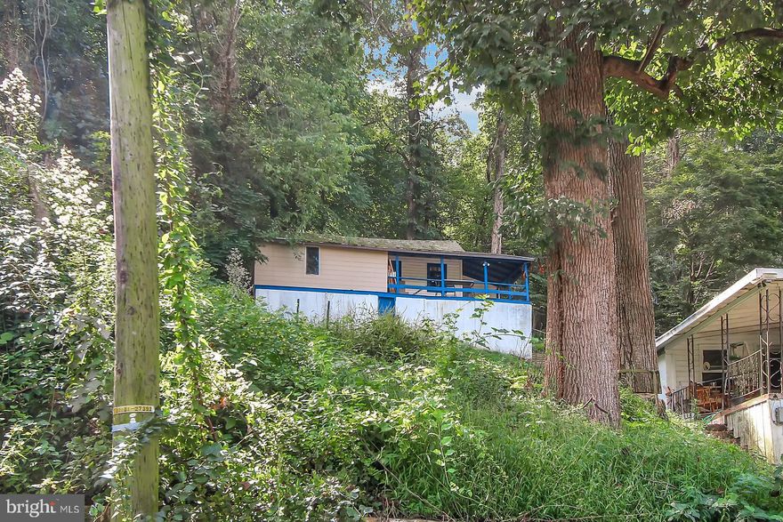 YOUR VERY OWN BUNGALOW overlooking the Conewago Creek. Enjoy simple living in this cozy little home.  Relax on the covered front porch. Living Room is open to the kitchen.  Full bath has a walk-in shower and linoleum floor.  Front Room could be made into a 2nd BR. Seller recently replaced the roof over this room and  replaced the drywall and repainted.  It now has washer and dryer hook-ups in this room, but they could be relocated if  you would want to use this room as a bedroom. Most windows have been replaced. The basement is only accessed by an outside entrance, it has drywall walls, could be made into a  small workshop.  Shared well with 1835 and shared driveway (recorded maintenance agreement in deed). No sign. The driveway is across from house #1820. It is the 2nd home on the driveway located at the top of the hill.  You may need a 4x4 to come up the driveway.  DO NOT PARK  in neighbor's driveway or block access to their home. You must drive beyond the neighbor's house to park.