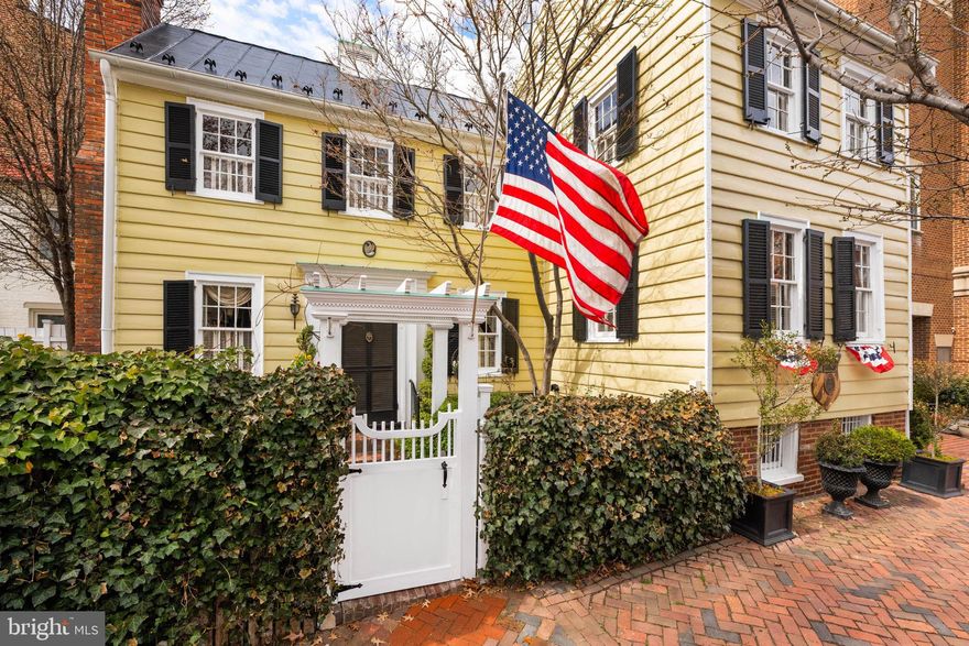 A rare piece of Alexandria history!  123 S. Pitt Street stands on land once owned by George Washington, offering a remarkable connection to Alexandria’s early history. In 1763, Washington purchased the half-acre parcel at the corner of Pitt and Prince Streets as Alexandria expanded beyond its original boundaries. In 1797, he subdivided the property into smaller building lots, and modest frame houses were constructed soon after, later known locally as the “Washington Tenements.” Today, the property remains a tangible link to Alexandria’s earliest years and to Washington’s vision for the city’s development. Now offered for sale, this is a rare opportunity to own a detached historic residence in the heart of Old Town Alexandria. This exceptional three-bedroom, two-bath home is distinguished by its iconic curb appeal, timeless architectural presence, and a unique, highly functional floor plan. The main level features a gracious living room with a fireplace and a formal dining room with its own fireplace, while numerous windows create a bright, light-filled interior. The inviting kitchen offers convenient side-door access. The thoughtfully excavated lower level creates an extraordinary family room with a striking black-and-white checkerboard marble floor, dramatic stone walls, exposed brick foundation, and original 1800s framing timbers, resulting in a truly remarkable space. Upper levels include three well-proportioned bedrooms and a finished attic providing flexible additional space. Original architectural details remain throughout, reflecting generations of careful stewardship and respect for the home’s historic character. Outside, a private gated garden offers a peaceful retreat in one of Old Town’s most desirable locations, just moments from the waterfront, shops, and restaurants.