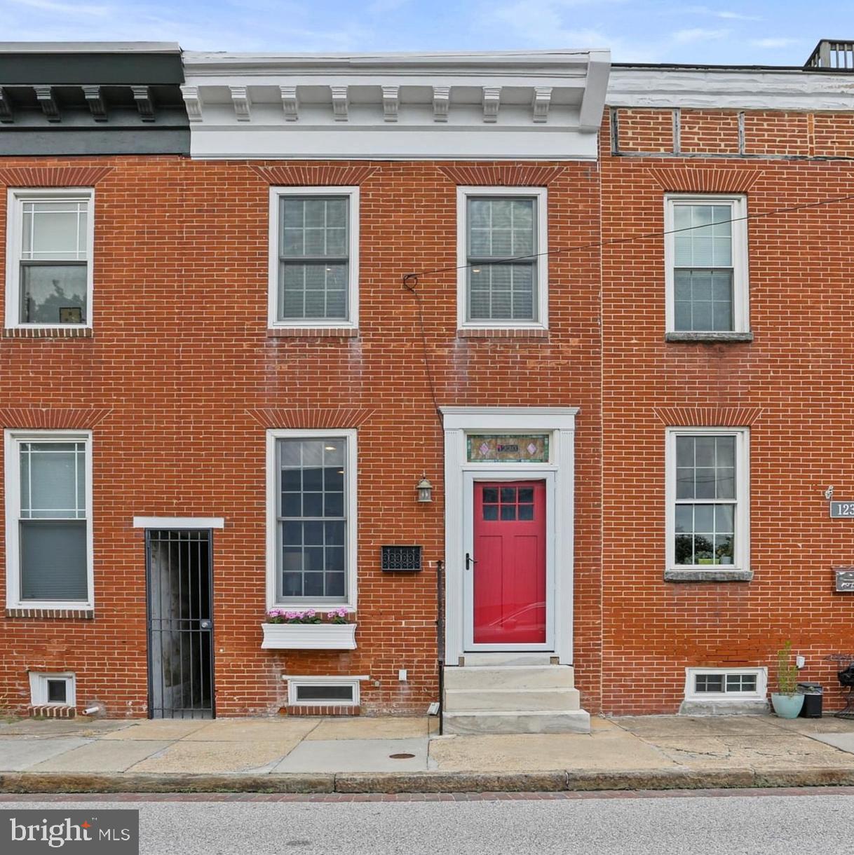 Welcome home to this updated brick-front 2-bedroom, 2.5-bathroom town home boasting 1200+ sq ft above grade in the highly desirable Locust Point! This home has been lovingly maintained and you’ll be delighted by the charm of this property and its central location, including convenient access to the water and the water taxi. Throughout the home, beautiful gleaming hard wood floors are displayed with the main level and stairs being newly refinished. Original exposed brick and crown moulding provide warmth and charm! The main level offers a bright, open floor plan with recessed lighting and built-in shelves that convey. The updated and spacious kitchen offers ample cabinet and counter space, stainless appliances with a gas range, 42" maple cabinets, granite counters, and a breakfast bar. Beyond the kitchen is a half bath and a large coat closet. Venturing out back, there is a delightful private patio with a privacy fence. The front gate leading to the rear offers convenience for hauling gardening items, bikes and more! The upper level features two generous size en suite bedrooms, perfect for a roommate or guests. The en-suite located towards the front of the home offers an exposed brick wall, a ceiling fan, vaulted ceilings, recessed lights, neutral paint and a tastefully updated full bath. A vaulted ceiling with recessed lights is also a highlight of the rear bedroom and the en-suite bathroom has a stand up shower with a newly installed glass door. Replacement windows throughout the home are another bonus feature. The unfinished basement is immaculate and perfect for storage or a workshop. Ideally located, the street is quiet and provides ample parking. Within blocks you will find local restaurants, bars, grocery stores, gym as well as Latrobe Park (with athletic fields, pickleball and tennis courts, playgrounds, a dog park and more!). Not to forget Fort McHenry! Relish all that Locust Point offers at McHenry Row while also enjoying neighboring Federal Hill and all that Baltimore City has to offer! All within minutes to major highways, 10 min to train to DC, 15 minutes to BWI airport and major universities and hospitals!!