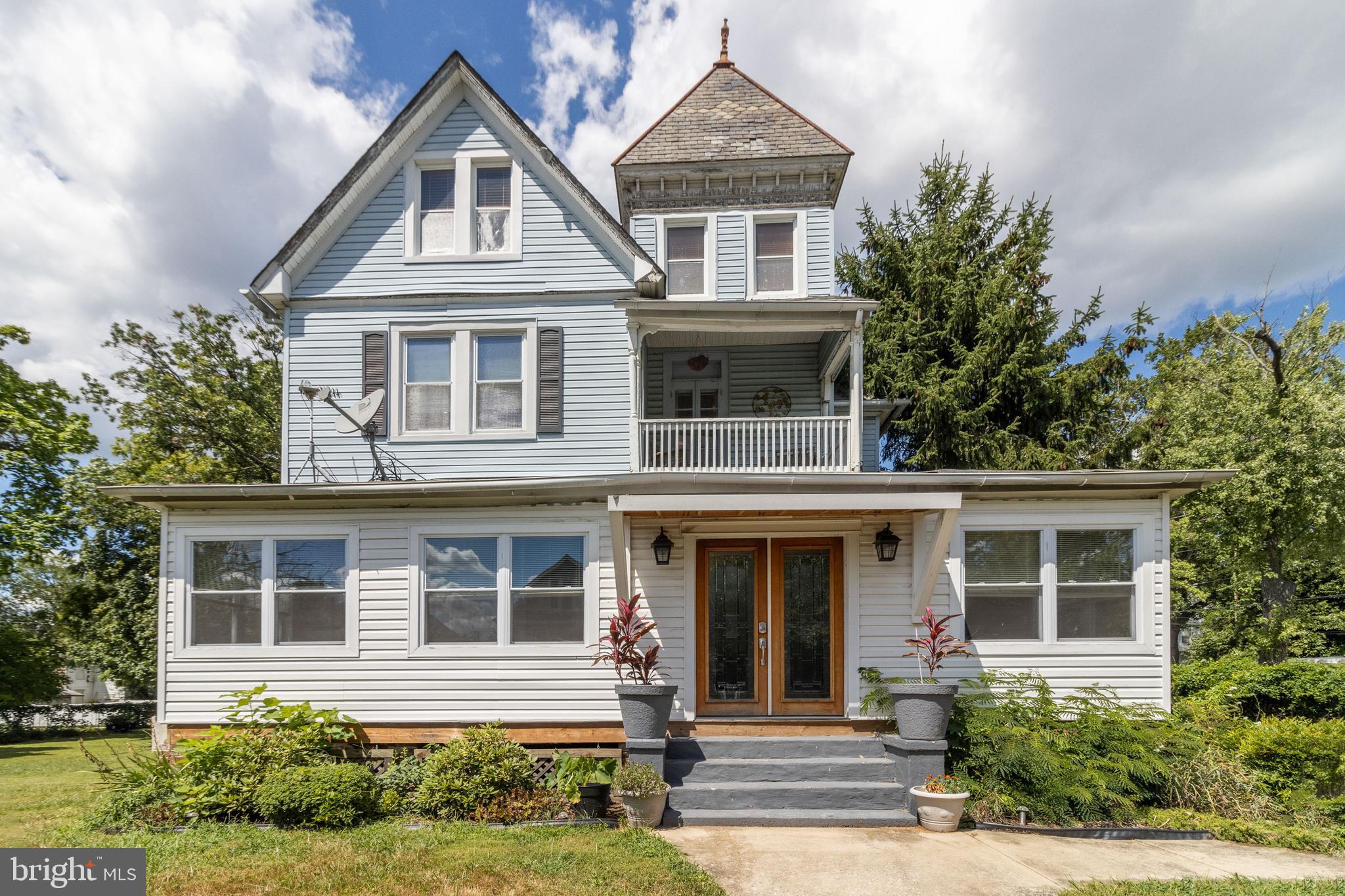Welcome to this lovely historic home built in 1894. There are three levels of living area, all above ground. As you enter the home you walk into a closed in porch, that wraps around the front part of the house. You can sit and not be bother with the bugs flying around all while enjoying the view as you watch the neighbors walk the neighborhood. As you enter the home you come in the inviting foyer and off to the left is the formal living with a fireplace or wood stove type. Staying on that side of the house there is first floor master with it own ensuite as well as an entry door that can take you to the outside of the property. If you go back towards the door to the right side of the house there is a grand dining area for large family gathering. The holidays are coming up and this room can seat many. There is a short hallway that leads to the kitchen and the half bath. When entering the hallway or you immediate left is the large chef's delight kitchen area. Not only is there room for a large kitchen table but the is a breakfast bar as well as lots of prep area for cooking your large holiday meal. The kitchen has been updated with double ovens, cook top, lots of cabinets as well as lots of light. Before exiting to back yard, stroll upstairs. The second floor has a what could be called a grand master bedroom with walk in closet, sitting area, and of course tub and shower ensuite. It is so relaxing, just come in sit a while. A great place to retreat for the evening. Just down the hall are two other bedroom both that have their own baths and lots of nooks and crankies in every room all over the house. Then there is the third floor. This old home has so much to offer take the time to really enjoy the home as you walk thru. On the third floor there are two more bedrooms. So just to keep count, one on the first floor, 3 on the second floor and two on the top floor. Each room comes with their own uniqueness and you have to walk into the room and discover that for your self. If you have a big family this is the place for you. Even though the property was built in 1894, it is not on the Historic Registry, the current owner did not want some of the historic restrictions placed on the home. Now, let talk about the back yard. This home sits on about a half acre of land. There is a Koi pond on the left side of the back yard and the pond and fish remain. The backyard has been the place for anniversary parties, outdoor wedding, and more. If you have a vision you can see hosting an outdoor wedding. There is room for sitting for the ceremony on one side of the yard and partying and have dinner or lunch on the other side. There is a large deck, a large patio and a large cooking area. There is a large parking pad on the right side of the property and during the party time there is a lot of street parking around the property, either on the side street or the front street. Lastly, there is a basement, not finished and the entry is off the back side of the home. It is a great place for storage, the hot water heater, boiler system for the radiator system, and more are in the basement. The owner is even leaving you a nice surprise. This home has so much to offer and it can be yours to call home.