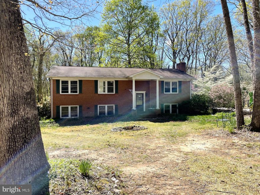 This 4BD, 3BA, almost-2,800 FSF home is just waiting for you to come along and implement your vision for the place. This is a sturdy, split level, brick home with plenty of room to really spread out and live your best life! It is nestled on 1.18 acres on a quiet cul-de-sac. Upon entry and going upstairs, you will find a living room, a dining room, a large eat-in kitchen with stainless steel appliances and granite countertops, a sunroom with a skylight, a full bathroom, the primary bedroom with ensuite bathroom & walk-in closet, and 2 more bedrooms. Downstairs, you will find a huge rec room with a brick fireplace, a full bathroom, a 4th bedroom, a spacious laundry room with bonus fridge and utility sink, a utility room, and a bonus room (could be a 5th bedroom or office or media room, whatever you like). There are also some great outdoor living spaces: a lovely deck with entrances to the sun room and the primary bedroom, and a great stone patio area, accessible through sliding glass doors in the rec room. There are also 2 sheds for added storage space. The home has lots of great features, like: original wood floors, a built-in bookcase, a front loading washer and dryer (about 5 years old), crown molding, chair rail, etc… This home is being sold AS-IS, and the great price reflects that. Do not miss your chance to own such a grand home on a such a nice, large lot!