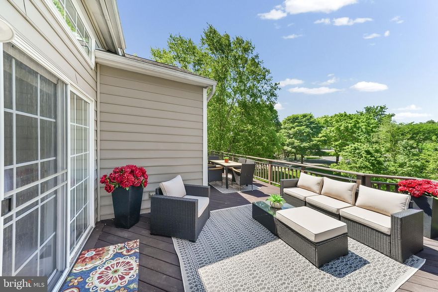 This is the one that you have been waiting for! Located in Chester County's premier 55+ Gold Star community, Traditions at Longwood, this home is close to Longwood Gardens, Downtown Kennett Square, Chadds Ford, Glen Mills, Greenville, Wilmington, Newark, Philadelphia, Philadelphia Airport, Baltimore, the Brandywine River & Museum, Whole Foods, Wegmans, The Fresh Market, Trader Joe's, numerous retail stores, restaurants, nature parks, trails, PA Wine Trail & vineyards, birding, golf courses, horseback riding and so much more. Within the community, you can enjoy the community garden, pools, tennis, pickleball, walking trails, etc. This particular home is located in the desirable PHASE 1 of this community and occupies a PREMIUM LOT which is walk-able to the club house, overlooks the pond area, and has a  TRUE WALK OUT BASEMENT FINISHED BASEMENT; the location affords serene privacy and beautiful views of trees and nature from the outdoor living space. This is the MAYFIELD model which is the largest square footage model constructed here; between its premium size and premium location in the community, this home is truly a rare opportunity. From the time you pull up to the home, to the time you complete your tour, you will be impressed with the condition of the property, the wonderful molding and architectural details throughout, and the upgraded fixtures and finishes. The formal living room is located just off the main entry, is generously sized and boasts a coffered ceiling. The formal Dining Room is just beyond and it has an upgraded chandelier and lovely wainscoting and moldings plus a dry bar between it and the kitchen. The kitchen is fully open to the family room and boasts beautiful new quartz counter tops, light filled windows, a gorgeous eat around center island,  two closets (pantry and other) plenty of eat-in space and direct access to the garage. The family room just beyond has an exit to the outdoor, maintenance free deck as well as a marble, natural gas fueled fireplace. The primary bedroom and bathroom are conveniently located in the back of the home with gorgeous windows that frame the stunning views behind the home perfectly. The primary bedroom has tray ceilings, a spacious sitting area, a large walk-in closet plus a wonderful en-suite bathroom with a large tub, separate stall shower, separate toilet room, and a long double sink vanity. The main floor also has the laundry room and powder room located near the kitchen and dining rooms. The second and third bedrooms and second full bath as well as a second floor family room/office/den are located on the upper level.  Through one of the bedrooms, there is a fully built out hobby room with plenty of storage and a large, center work table. There are two HVAC units in this home. This home has upgraded finishes such as hardwood and tile floors throughout and wonderful custom columns, panel box molding, crown molding, arches, and ceiling details in many of the rooms. The basement is fully finished with a FOURTH BEDROOM and THIRD FULL BATHROOM and a huge recreation space  with an at-grade walk-out sliding glass door and small patio area under the deck. Traditions at Longwood has some of the nicest amenities of any over 55 community in the area: two clubhouses, a beautiful community pool with plenty of seating and a lovely pergola covered area, a community garden area, tennis courts, pickellball courts, bocce court and a billiard and card room, plus plenty of scheduled activities and community events. The HOA takes care of everything: grass cutting, flower beds, snow removal on driveway, front walkway/steps & streets, trash, recycling, clubhouse, library, social/events room, fitness center, spa, sauna, common areas & a community pond with its own famous white swans. Make your appointment today to come see this lovely home. The finishes, condition, lot features and location make this a truly special home.