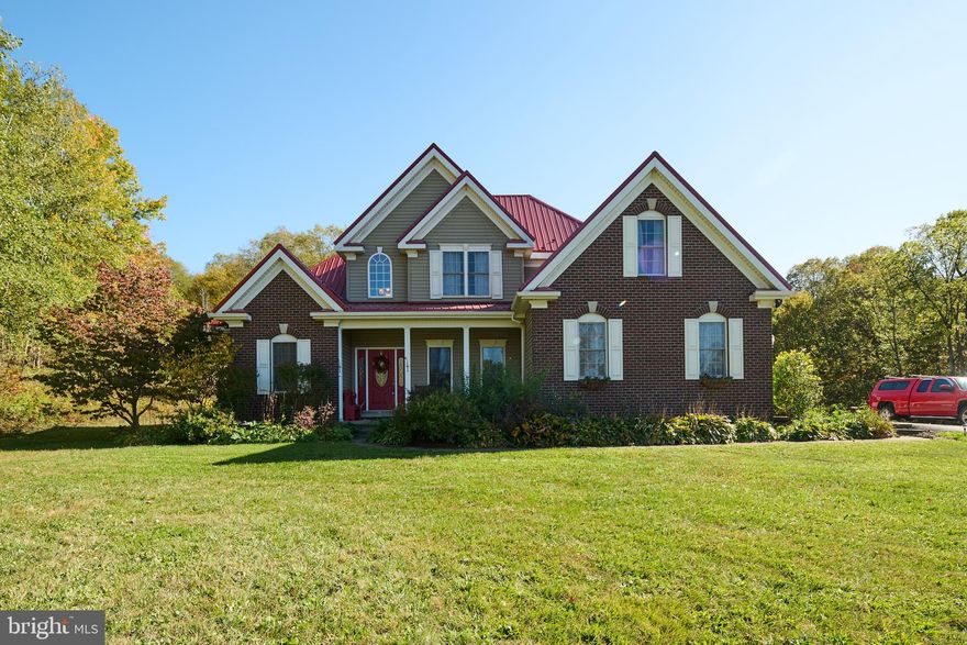 Elevate Your Lifestyle with this Captivating Two-Story Brick Home situated on an 8.26-acre lot. This 4-bedroom 2.5 bath home features a large foyer area that leads into the family room with cathedral ceilings and stone fireplace. An open kitchen offers Oak Cabinets, stainless appliances and granite countertops. First floor offers large dining room, laundry room, and half bath, First floor owner's ensuite with shower, double bowl vanity and jacuzzi tub.. Upstairs you have 2 bedrooms and a full bathroom and a bonus room that could be a 4th bedroom, office, or recreation room. Exterior features include a large, covered deck, and a new roof. The basement is partially finished and has room for future expansion. Features include Solar panel for low energy bills for heating and cooling. A generator & 2 car garage. This home is close to Cold Stream Dam and a short drive to State College, PSU, or Altoona.