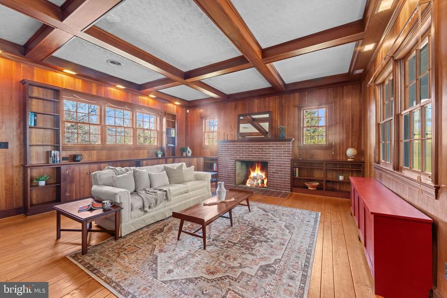 OPEN HOUSE FEB 7, FROM 11-1. 
Set on 6 picturesque acres, this exceptional all-brick estate offers 4 bedrooms, 3.5 baths, and nearly 5,000 square feet of timeless craftsmanship, thoughtful design, and outstanding outbuildings. The home features four fireplaces, and all-natural wood floors. A bedroom and full bath are conveniently located on the main level. Nine-foot ceilings define the main floor, which includes open stairs with gorgeous chestnut wood railings, a formal living room with brick fireplace and wood mantel, formal dining room, office, den with a brick fireplace, family room with a brick fireplace and walk-in coat closet, kitchen, and half bath. Six doors on the main and lower levels provide direct access to porches, patios, the driveway, and the yard, while large windows on every level fill the home with natural light.
The crown jewel of the home is the richly appointed den, showcasing exquisite woodwork, custom built-in bookshelves, a 9-foot beamed ceiling with recessed lighting, and a brick fireplace. Two separate doors lead to the enclosed front porch and the expansive backyard, offering seamless transitions between interior spaces and outdoor living areas.
The upper level offers three additional bedrooms and a full bath, featuring wide hallways and abundant windows that create a bright, spacious feel throughout. Bedrooms are generously sized with ample closet space, and a walk-in cedar hall closet provides additional storage. Both the upper- and lower-level full bathrooms reflect classic early-1900s design including mosaic floors and have been preserved in impeccable condition. 
The basement is accessed by two separate staircases—one leading to a workshop area and the other to a finished family and recreation room complete with a small full bath, bar, brick fireplace, and a separate split HVAC system. Each basement area has its own exterior access.
Outside, the property is equally impressive with four quality outbuildings, including a 38’ × 60’ pole barn featuring a 14’ sliding door on the end and a 17’ sliding door on the side, a detached three-car garage with storage above, an 18’ × 30’ chicken coop, and a mill house suitable for use as a horse barn with hay storage. Not counted as one of the outbuildings is a former tenant farmer shack that was occupied as a dwelling with running water and electric many years ago. Two water spigots and two frost-free hydrants support gardening, livestock, or equestrian use. The land is well suited for large-scale gardening, a horse farm, or livestock.
An efficient circular driveway provides access to the front of the home and continues to the rear, offering ample parking and ease of use.  A steal roof with an expected life of 70 years, or longer with  proper care, was installed in early 2000's, A new geothermal heating and air-conditioning system, exceptional brickwork, fine wood detailing, and outstanding overall condition further underscore the value of this stately residence. 
A truly special offering for the discerning buyer seeking space, privacy, craftsmanship, and enduring quality. The property is ideally situated near the interconnected conservation lands of Patuxent River Park and Merkle Wildlife Sanctuary—providing unparalleled access to 9400 acres of protected parkland, waterways, and miles of scenic trails for hiking, horseback riding, kayaking, and Ranger-led activities for children. Convenient commuting access—approximately 40 minutes to Washington, DC; 35 minutes to the Pentagon; 22 minutes to Joint Base Andrews; and 44 minutes to Fort Meade.
240-714