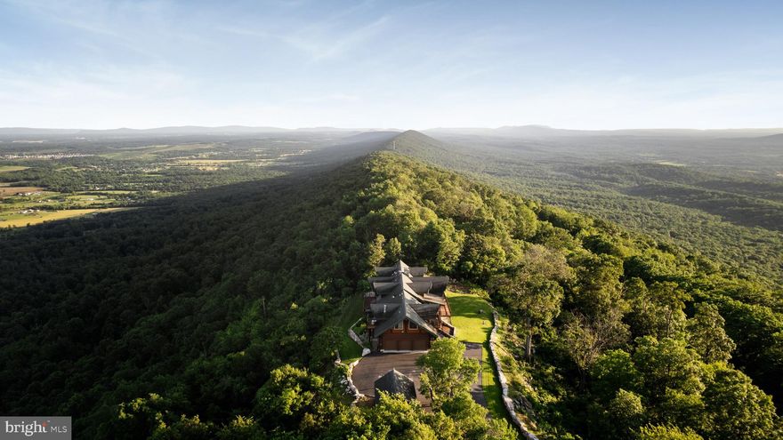 Absolutely extraordinary and breathtaking— Welcome to your custom, one of a kind dream home—a luxurious 7-bedroom, 6-bathroom log cabin mansion ( over 7000 sqft ) that exudes elegance and comfort. Breathtaking 360 degrees views, almost 20 private meticulous kept acres and grounds with professional landscaping. This magnificent chalet boasts beautiful hardwood floors and impressive log beams, complemented by two stunning stone fireplaces that create a cozy yet sophisticated ambiance. Main level offers a chefs kitchen with commercial grade appliances and luxury leather style granite countertops, dinning space for an 18 person table, 2 story family room and sitting room with access to extensive trac decking, foyer with stone flooring and access to another large private trac deck, half guest bathroom, 2 guest rooms with a full bathroom. Up the custom staircase to the upper level you’ll find the Primary Suite with access to a private balcony, attached bathroom with incredible views - double sinks, private toilet room, walk in shower, as well as a walk in cedar closet. Down the catwalk-way more never ending views and sitting nooks to your bonus sitting area over looking below dinning space. Walk out level offers multiple access points to exterior private patios - Entertain in style with a fully equipped bar and game room designed for hosting unforgettable gatherings,  large family room, 2 guest rooms, 2 full bathrooms, laundry room, and storage space. Across the breeze way is the 3 car garage with 12ft+ ceiling and ample amount of storage space. Above features a one of a kind 2 bedroom , 1 full bathroom with kitchen, dinning area, family room apartment with 2 private balcony’s to watch the sunrise and set from.

Every angle of this home offers breathtaking views — you’ll feel on top of the world, top of the line materials, fixtures and finishes while expansive decks provide the perfect spot to unwind and soak in the serene surroundings. Paved driveway with ample amount of parking. Nestled in a quiet, private, estate neighborhood, this exquisite residence offers tranquility without sacrificing convenience, with a short drive to Interstate 81 making commuting effortless. Experience the epitome of luxury living in this extraordinary log cabin mansion.

All the exterior logs have been maintained and stained, New HVAC, Metal Roof, New Kitchen, over 200 LED recessed lighting, whole home speakers, professionally decorated- high end custom furniture (** seller prefers it to convey), Landscaping, the list goes on. ** Private approved showings only **