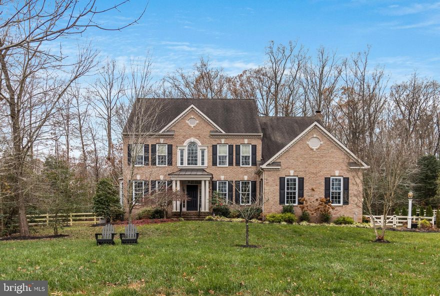 Welcome to this stunning four-bedroom, 3.5-bath home, situated in the desirable River Creek Estates of Davidsonville, Maryland. Set on 1.54 acres, this beautifully updated residence offers over 4,400 sq. ft. of living space across three levels and has been meticulously renovated since its purchase in 2019. As you enter the main level, you’re greeted by a grand two-story foyer with dual staircases, complemented by rich hardwood floors that flow seamlessly throughout the open-concept design. To the right, a spacious formal dining room awaits, while to the left, a versatile flex room, separated by a stylish barn door, serves as an ideal office or library.
The chef-inspired kitchen is a culinary masterpiece, featuring abundant cabinetry, quartz countertops, and a large island with a gas cooktop, double ovens, and top-of-the-line stainless steel appliances. The kitchen flows effortlessly into the cozy dining area, which leads out to a sizable deck overlooking the expansive patio and lush backyard – the perfect space for entertaining, gardening, or unwinding in tranquility. The inviting family room is enhanced by a natural gas fireplace with a striking stone surround, adding warmth and character. A playroom, convenient half bath, and laundry room complete the main level.
Upstairs, the luxurious primary suite is a true retreat, offering a vaulted shiplap ceiling, a spacious walk-in closet, two additional closets, and a spa-like en-suite bath with a soaking tub and double vanity. Three generously sized bedrooms and a guest bathroom provide ample space for family and visitors. The large walkout basement is an entertainer’s dream, featuring a game room, bar, recreation room, full bath, and plenty of storage. A three-car garage adds even more convenience and storage options.
Situated in a highly-rated school district and just minutes from Annapolis, with easy access to major commuter routes to DC and Baltimore, this home offers the perfect blend of luxury and convenience. Welcome to your dream home!
