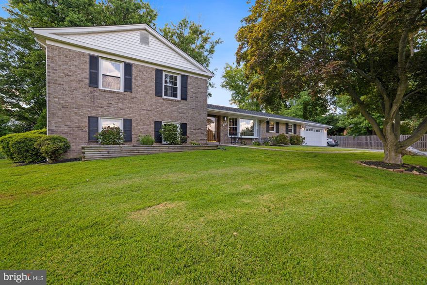 OPEN HOUSE THIS SATURDAY FROM 12 TO 2 PM.  We are pleased to present this large Ranch style home with main level au pair suite, open kitchen/ dining/ living room floorplan with hardwood floors throughout.  The kitchen offers stainless steel appliances, granite counters, dual ovens, and a gas cooktop.  Upstairs there are 3 more bedrooms, including an 2nd ensuite bathroom.  The lower level offers a grand family room, an additional bedroom with full bath, and separate storage rooms. The yard is both deep and wide and all directions, and includes a screened-in rear porch and additional patio.