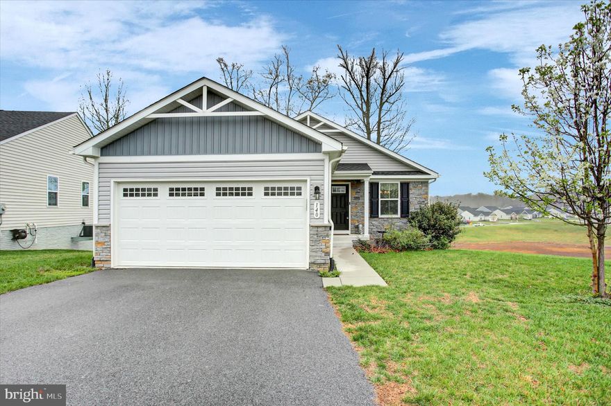 Adorable one-level living in The Lakes at Martinsburg! This charming 2-bedroom, 2-bath home features luxury vinyl plank flooring throughout the open concept main level with a beautifully designed kitchen complete with stainless steel appliances and a spacious island—perfect for cooking and entertaining.  An extra room on the main level offers additional space great  for an office. There is a  large deck off the main level with a patio below with views of trees and the pond!

The unfinished walkout basement with sliding glass doors offers great potential and is already plumbed for an additional bathroom, giving you room to expand. Enjoy the convenience of an instant hot water heater for added efficiency.

The community offers amenities including a dog park, picnic area, and playground, all in a prime location with easy access for commuters.