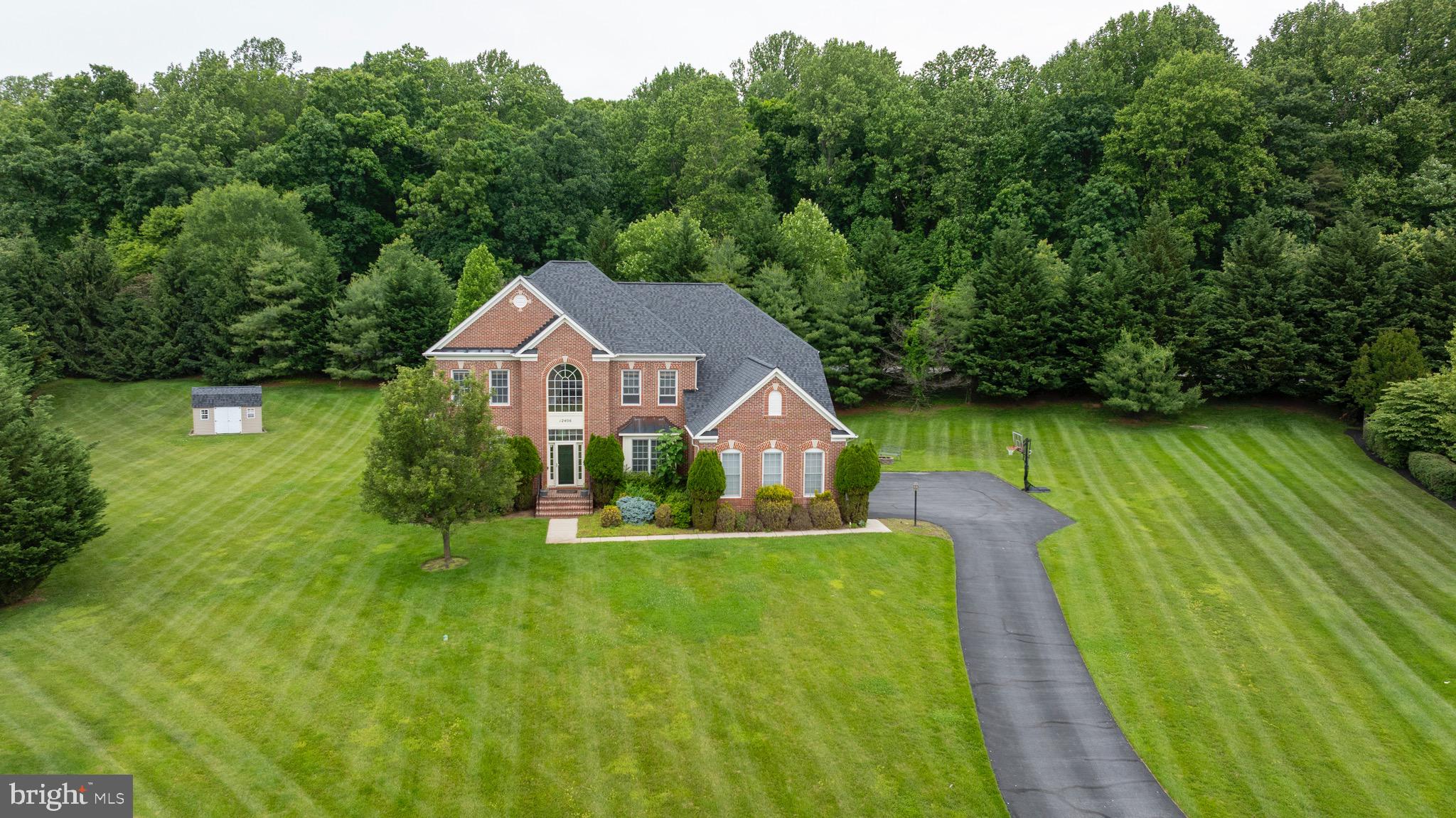 Welcome to this exceptional 5-bedroom, 4.5-bathroom colonial with over 6,500 square feet of finished living space, nestled on a private 1.2-acre lot in the sought-after Fields of Sagamore community. Located on a quiet cul-de-sac, this home offers a seamless blend of indoor and outdoor living, perfect for both everyday comfort and entertaining. The main level is flooded with natural light, featuring oversized windows, a cozy family room with a gas fireplace, and a spacious eat-in kitchen with granite countertops, stainless steel appliances, a large walk-in pantry, and an oversized island with seating. Step outside to the patio, where you can relax, unwind in the hot tub, or gather around the built-in fire pit – all while taking in the serene, tree-lined views. The backyard also includes a convenient shed, providing additional storage for outdoor essentials. Up either of the dual staircases, you’ll find a luxurious primary suite featuring a tray ceiling, two walk-in closets, and a spa-like en-suite bath with dual sinks, a soaking tub, and a separate shower. Four additional bedrooms are thoughtfully designed with two Jack-and-Jill bathrooms, each offering dual-sink vanities for added convenience. The lower level is designed for entertaining, with walkout stairs, high ceilings, a wet bar, a walk-in pantry, two versatile bonus rooms (one currently set up as a workout space could be used as a 6th bedroom), a full bath, and ample storage. Additional features include a 3-car garage with an electric vehicle charger, providing both convenience and sustainability. Residents of the Fields of Sagamore community also enjoy access to playgrounds and open space, with easy access to Glyndon, I-795, and the Reisterstown Corridor. This home truly has it all – don’t miss the opportunity to make it yours!