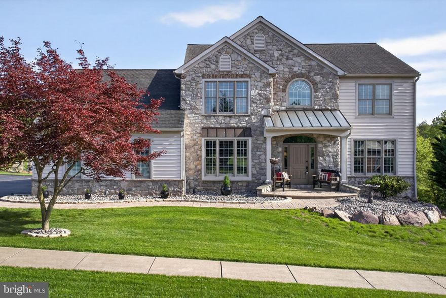 Beautifully maintained and in exceptional condition, this 4-bedroom, 3.5-bath home sits on a spacious .63-acre lot in the Dallastown School District and offers a clean, neutral interior that shows like new, with fresh paint and updated flooring throughout the main level and second-floor hallway. The layout flows easily from the foyer through the main living spaces into the well-appointed kitchen featuring granite countertops, a Sub-Zero refrigerator, and Thermador gas cooktop, along with a generous pantry. The main level also includes a gas fireplace, adding warmth and character to the living space. Upstairs, the primary suite features a vaulted ceiling, walk-in closet with custom shelving, and updated privacy doors to the bath, while the remodeled hall bath offers a walk-in shower, new vanity, and updated fixtures. The finished lower level provides excellent additional living and entertaining space with a custom bar, stonework, full bath, natural light, and a pellet stove. Additional highlights include plantation shutters throughout, central vacuum, and an updated laundry room with new utility sink, cabinetry, and shelving. Outside, enjoy the expansive yard, patio, and an oversized 3-car garage with finished flooring and ample driveway space. A truly special home with so many beautiful features that must be seen in person.