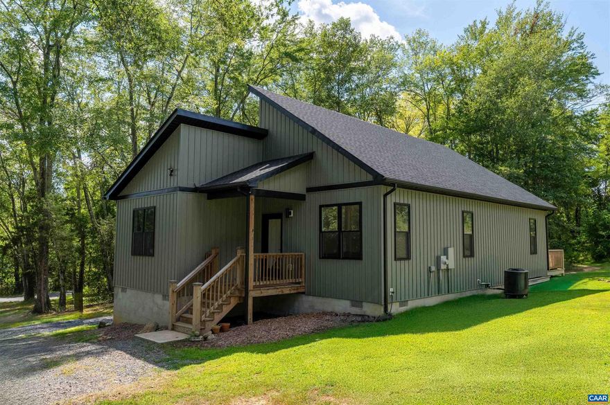 Two year old open-concept home in up and coming Scottsville!  This nearly new home built in 2023 exemplifies all of the trappings of a modern life while allowing one to maintain the ease of private, rural living.  Enter into the open living area featuring tall cathedral ceilings filled with light pouring through the numerous windows.  The spacious living area transitions gracefully into the large kitchen that includes an oversized island, gorgeous granite countertops, stainless steel appliances, and a huge pantry.  The primary suite is located in the back of the home, and is complete with a spacious walk-in closet.  The primary bathroom lives large, finished with a dual vanity and glass sliding door walk-in shower.  Off the dining room, one can walk out onto the wood deck that surveys the rolling grass and woodline that frames the property lines.  Stroll through the yard and onto the trail that leads into a forested portion of the property to enjoy those extra hot days outside under canopy.  Just minutes from downtown Scottsville, the Scottsville Center for Arts and Nature, award winning wineries on the Monticello Wine Trail, and the James River.,Granite Counter,White Cabinets,Wood Cabinets