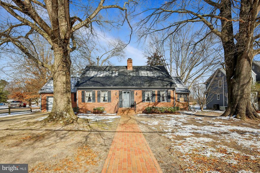 Welcome to 211 Bloomingdale Ave. This custom‑built Brick Williamsburg‑style colonial showcases true craftsmanship, featuring beautiful hardwood floors throughout, custom built‑ins, and detailed moldings. The spacious living room offers an inviting wood‑burning fireplace, while the large great room with its vaulted ceiling provides flexible living space and could easily be converted into a third bedroom if desired.

The bright, well‑appointed kitchen is ideal for anyone who loves to cook, offering ample room for a kitchen table and direct access to a separate formal dining room—perfect for hosting guests. A convenient half bath is located on the main level, with a full bath upstairs along with two generously sized bedrooms and a large walk‑in storage area.

Outside, a concrete driveway leads to an attached garage.  There is a brick walkway from house to the town sidewalk.  Spacious private backyard with mature trees and a newer roof.  This home is truly move‑in ready and waiting for you to enjoy.