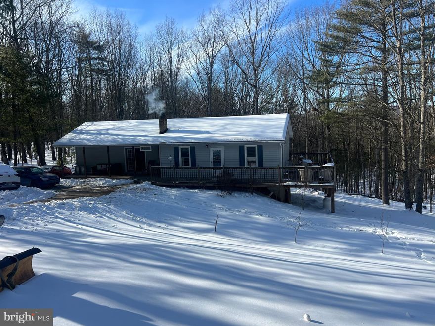 Looking to get away from the hustle and bustle. This is the home. Situated 1.2 acres of a wooded lot and practically no traffic. Cooled in the summer by shade trees, warm in the winter by a cozy wood stove. Roof is only 5 rears old. Large master bedroom with private bath. Huge family room on lower walk out level. Attached and detached garage. Whether a weekend get away or year round home, this is a great location. Near Green Ridge State Forest, Rocky Gap Resort with Campground, Lake, Golf Course and Casino. Only minutes from Cumberland and about an hour from Deep Creek Lake. Come check it out.