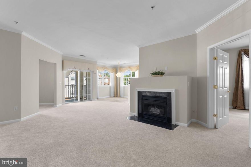 Welcome to this inviting, light-filled 55+ third-floor corner unit featuring 2 bedrooms, 2 full baths, and a den.  This is one of the largest floor plans available, offering 1,336 sq ft. Recently updated, this home includes a newly renovated second bathroom, new carpet, new and upgraded appliances, and fresh paint throughout. Two garage parking spaces and a private storage unit are included. The kitchen flows seamlessly into the dining and living areas, offering defined spaces while maintaining an open feel. The cozy living room features a gas fireplace—perfect for relaxing evenings at home. Step outside to your private balcony or enjoy a peaceful walk around the lake. Ideally located just steps from shopping and dining, including Target, Wegman's, retaurants and more—all within walking distance. Don't miss your opportunity to make this your home.