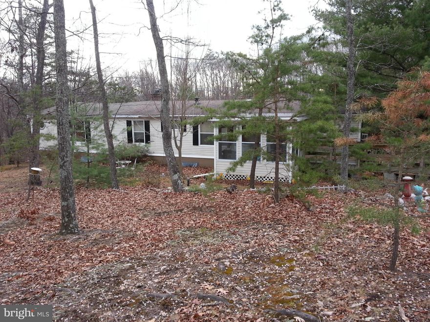 Over five private acres, mostly wooded.  Nestled in Back Creek Valley this home has a rural atmosphere, but within 20 minutes of I-81. Original double-wide has large 24 x 24 two story addition with brick fireplace.  Double carport, storage shed and mobile home (to be removed) with second septic system.  This property is being sold "AS-IS", but with lots of potential. Priced below tax value.