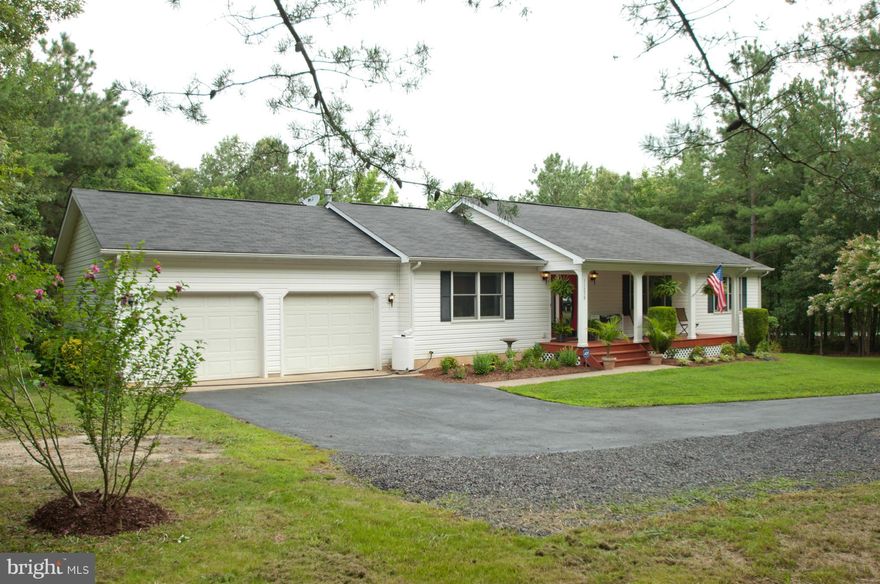 Country living with conveniences! Beautifully updated home on 2 ac. only 15 min. to Dahlgren or 30 min. to FXBG. Inside, the home boasts granite counters and tile, SS appliances, tiled MBA, lg. MBA shelved closet, stone gas fireplace,basement that runs full length of house with rough-in & full windows.The private driveway, shaded and hidden from road by trees, opens up to a lovely front porch.