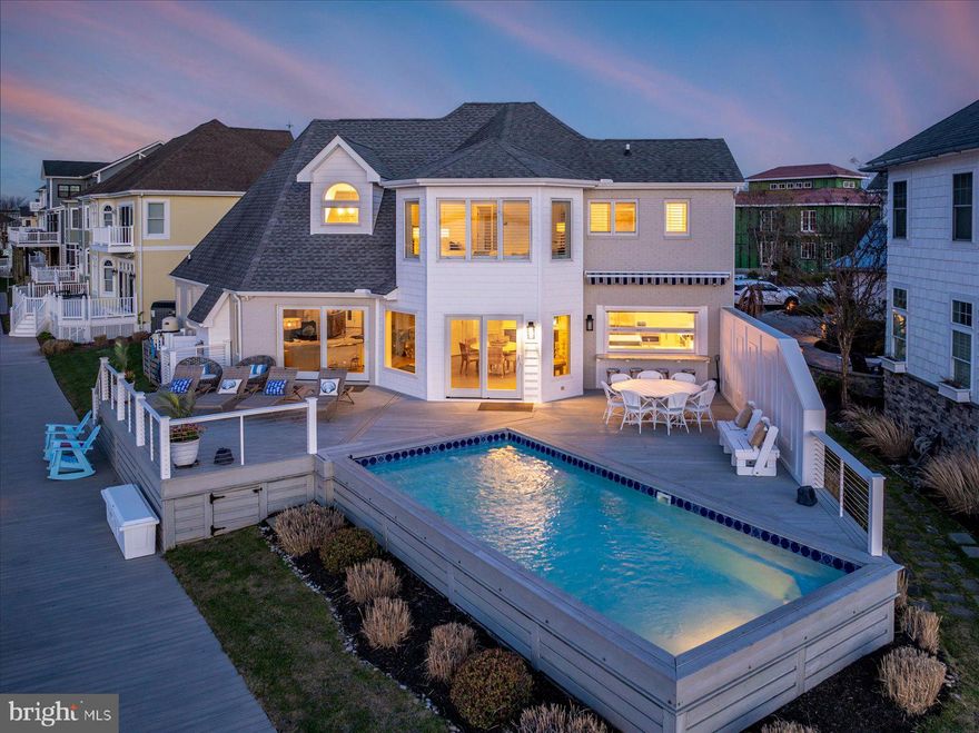 Welcome to Your Premier Coastal Retreat in Heron Harbour!  Discover the pinnacle of waterfront living with this exquisite 5-bedroom, 5-bath bayfront residence, perfectly positioned on the point in the coveted, amenity-rich community of Heron Harbour. With expansive, private frontage on the bay and panoramic water views, this home delivers a true luxury lifestyle—complete with your own private pool, boat docks, and breathtaking sunsets. Remodeled in 2022 by T&G Builders, the home features high-end finishes and thoughtful design throughout. Step inside to an open-concept layout where walls of windows frame the ever-changing bay, creating a light-filled, serene atmosphere reminiscent of a luxury yacht experience. The gourmet kitchen is a chef’s dream, boasting quartz countertops, a large center island, top-of-the-line appliances, custom cabinetry, a window pass through, wine cooler, and a built-in ice maker. A separate coffee bar and beverage center enhance the space for effortless entertaining. Enjoy meals in the bayfront dining area or relax by the cozy gas fireplace in the spacious family room as you take in those stunning sunset views. The first floor offers a generous en suite guest bedroom, an additional guest room, a full bath, and a convenient laundry area. Upstairs, the spectacular primary suite captures sweeping water views and features a spa-inspired bath with a jetted soaking tub and separate shower. A versatile loft area, two more bedrooms, and two additional full baths complete the upper level. Outdoor living is equally exceptional with a sprawling waterfront deck—ideal for barbecues, crab feasts, and summer gatherings by the pool. Boaters will love the newly upgraded docks, private boat lift, platform dock, and ample space for all your watercraft and toys. Professionally landscaped with irrigation and offered furnished, this home is move-in ready for immediate enjoyment. Residents of Heron Harbour enjoy world-class amenities including two outdoor pools, an indoor pool, baby pool, fitness center, sauna, two lighted Har-Tru tennis courts, locker rooms, library, and a clubhouse party room.  Whether you're seeking a luxurious year-round residence or a spectacular vacation home, this rare waterfront gem offers the best of both worlds.