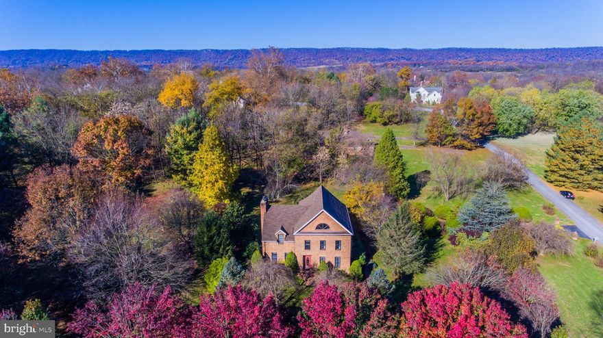 Sought after neighborhood centrally located but close to I81.  Beautifully built all brick home with Owner's Suite that includes a grand fireplace and sleeping porch, hardwood floors and Spa Tub with Separate shower.  Four floors include unfinished basement, main level with Formal Dining and Living Room with another grand Fireplace and walk out to private covered porch. Impressive Marble floored Foyer boasts a traditional Center Staircase and Pocket Doors to the impressive kitchen with Vaulted ceilings and skylights.  A wet bar central to the Kitchen, Living and Formal Dining Rooms handy for entertaining.  Dining Room has two storage rooms and opens to the kitchen and Foyer.  A main level Bedroom/Den connected to a Dual Entry Full Bath completes the main level.  Two additional bedrooms on the 2nd floor with a Jack and Jill Bath + 1/2 Bath.  Upper attic Level has lovely Windows with stunning views, fully finished.  Must see this gorgeous home. Won't last!