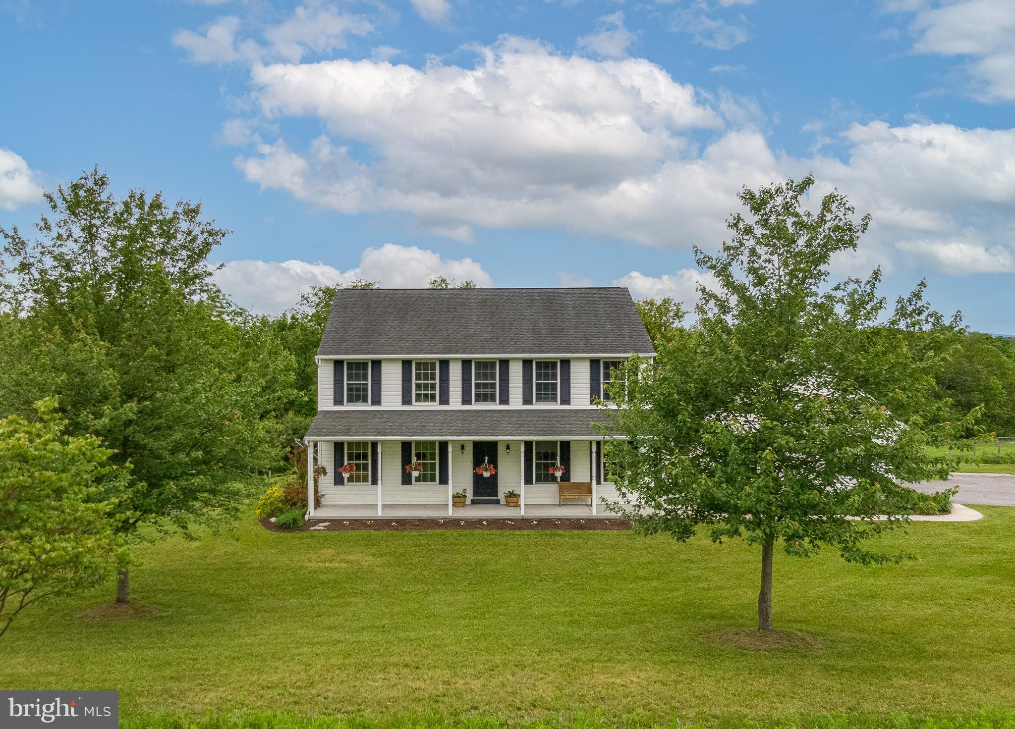 Welcome to 38 Seiger Lane, Shoemakersville, PA. Nestled on over 14 serene acres in Berks County, this well-kept two-story home offers space, comfort, and a beautiful slice of country living. With 4 bedrooms, 2.5 bathrooms, and a practical layout, it’s ideal for anyone looking to enjoy life with a little more breathing room. The main level features an open kitchen with generous counter space, cabinet storage, and a center island—perfect for everyday meals and casual gatherings. The formal dining room features a beautiful tray ceiling, adding a touch of elegance to holiday meals and special gatherings. There’s also a cozy, dedicated home office or library complete with built-in shelving—ideal for remote work, study, or a quiet reading nook. A first-floor laundry room and central air provide modern-day convenience. The detached multi-car garage adds flexibility for storage, hobbies, or equipment. Enjoy panoramic views of the surrounding hills and farmland from the large deck and covered front porch. The gently rolling acreage includes a creek, a spring-fed pond, and 10+ acres of open pasture. Mature fruit trees, blueberry bushes, and a raspberry patch provide charm and seasonal harvests. Ideally situated in Perry Township, this location offers a peaceful rural setting while remaining conveniently close to shopping, schools, and major highways. Enrolled in the agricultural preservation program, this country retreat benefits from reduced property taxes, making it an attractive investment. Whether you're dreaming of a hobby farm, an equestrian property, or just wide open space to enjoy the outdoors, this property offers room to grow and explore.