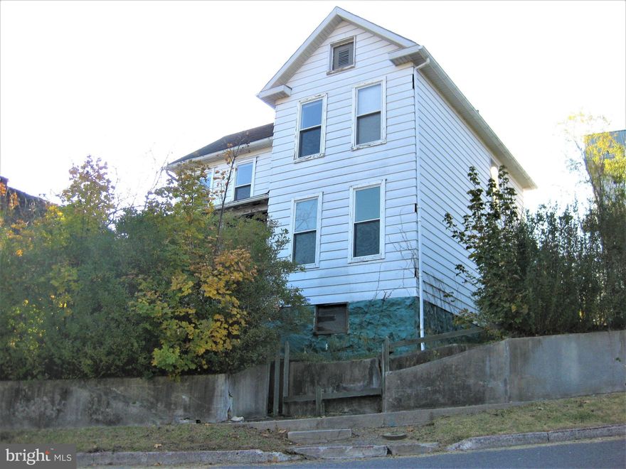 What a great opportunity! So much of the renovation work has already been completed in this house. The electric service has been upgraded to 200 amp service, the walls are fully insulated, all plumbing has been replaced, both bathrooms have been remodeled, all windows have been replaced with Energy Star windows, all new drywall in the house, and all the hardwood and pine floors have been refinished. There is great natural light throughout the house, and the views of the surrounding mountains are very nice. This house needs a new kitchen and a heating system. Natural gas supply is readily available in the basement. The property also has a detached garage and a carport to avoid on street parking.  This property would make a great family home.