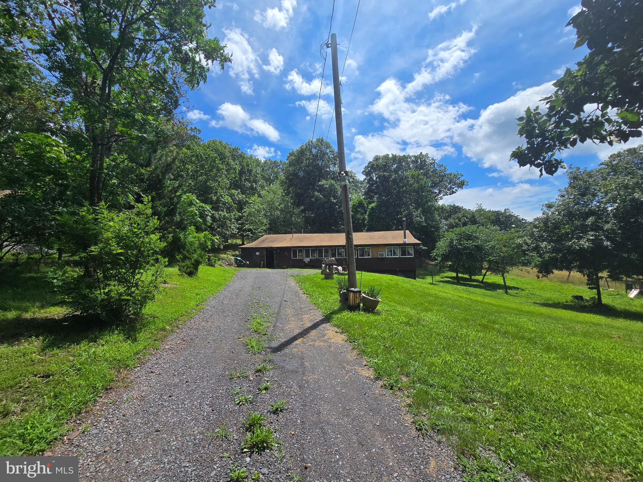 Welcome to 57 Ember Lane, tucked away in the scenic lake community of Sleepy Hollow. This hidden gem sits on a beautiful wooded lot, offering privacy, charm, and the chance to make it your own. With community lake access, serene surroundings, and room to grow, this home is perfect for those seeking a quiet getaway or full-time retreat. The neighborhood also features a baseball field, a picnic area with a pavilion, and an open field—perfect for relaxing, playing, or gathering with loved ones. Add your personal touches and enjoy all that this peaceful West Virginia setting has to offer.