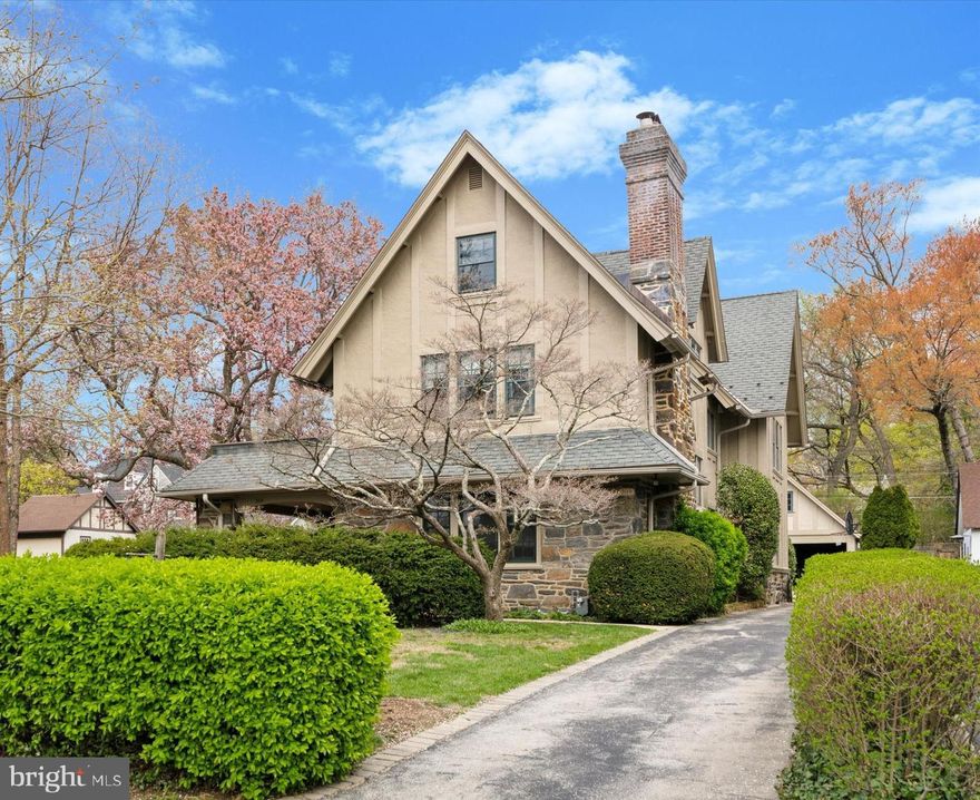 Welcome to 309 Hathaway Lane, a timeless and graceful 3-story home nestled in the heart of Lower Merion Township on the prestigious Main Line. This beautifully maintained residence sits on an expansive oversized lot and offers charm, character, and modern updates—all within easy walking distance of the Wynnewood train station, Wynnewood Shopping Center, Suburban Square, Whole Foods, Lower Merion High School, and many more local favorites.
Step inside through a generous front porch and into the welcoming front hall, featuring a winding staircase, powder room, and coat closet. The spacious living room has abundant natural light and a striking stone gas-burning fireplace. Perfect for entertaining, the formal dining room is detailed with elegant chair rail and crown molding and flows seamlessly into the butler’s pantry and gourmet eat-in kitchen. Home chefs will appreciate the stainless-steel French door refrigerator, double oven, and Poggenpohl cabinetry. An adjoining mudroom with ample storage and pantry space and a laundry provides convenient access to the sheltered side yard with a brick patio and to the driveway and detached 2-car garage.
Upstairs, the serene primary suite features two closets, its own fireplace,  a balcony, and a beautifully appointed en-suite bathroom with a clawfoot tub, pedestal sink, and classic subway tile. A connecting bedroom, currently used as a dressing room, offers flexible living space. Two additional bedrooms, one now used as a den/office, provide generous closets, one with built-in shelving, and share a hall bathroom with stall shower and a hall linen closet for extra storage.
The third floor adds even more versatility and is perfect for guests, hobbies, or a growing household. It has three additional bedrooms and a full hall bath with shower/tub combo. There is more than ample storage, which includes a separate room with a large cedar closet and multiple cedar-lined drawers. 
Additional features include high-velocity central air on the upper two floors, newer windows on the upper level, 200-amp electrical service, and a back-up generator for peace of mind. The expansive side and back yards are ideal for outdoor enjoyment or future expansion. Flowers abound and a tilled garden with raised beds is tucked behind blueberry bushes. 
Rich in original details and thoughtfully updated, 309 Hathaway Lane is a rare opportunity to own a spacious, walkable Main Line home in one of the area's most desirable neighborhoods. This is a must-see home!