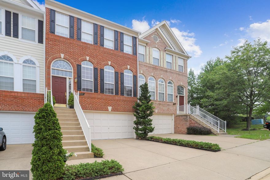 Like new! A beautifully maintained 3 level, 2 car garage, brick front townhouse in Ashburn Village.  
Built in 2000 by Robert Jordan, the home has had one owner, who has lovingly maintained and added several features that make this a very special home! The property offers 3 bedrooms, 2 half baths, spacious living room with wood blinds and hardwood floors,  dining room with tray ceiling and hardwood floors, master bedroom with vaulted ceiling, main level eat-in kitchen with new tile floor, family room with walk out to spacious deck and private rear yard, The lower level offers a  gas fireplace, new carpet, book shelves, half-bath, and walk out to your fully fenced private oasis!