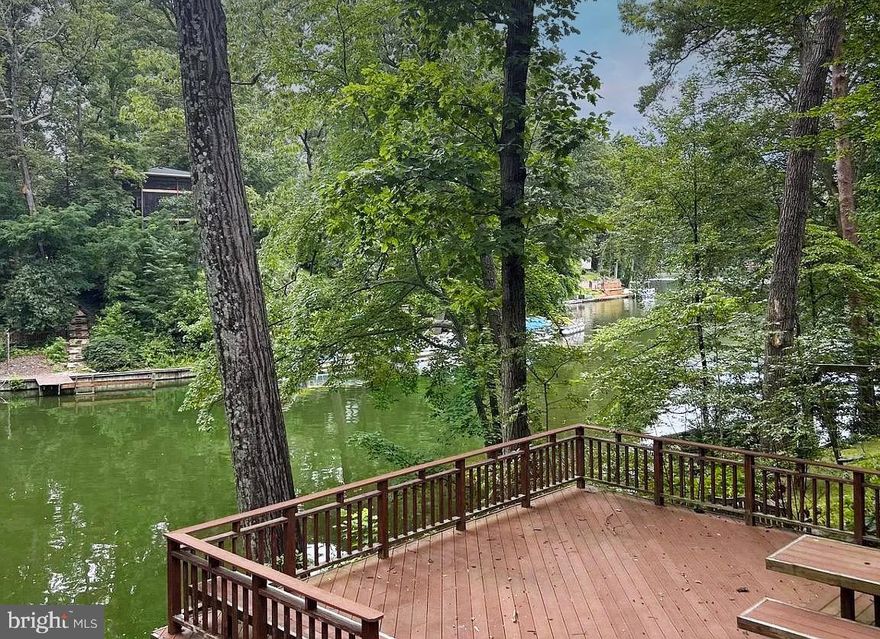 Lake Barcroft Waterfront! Enjoy the ultimate lakefront lifestyle in this home nestled on the shores of Lake Barcroft. The main level welcomes you with a gourmet kitchen featuring granite countertops, stainless steel appliances, and soft-close cabinetry. The spacious dining and living area offers breathtaking views of the lake, perfect for relaxing or entertaining. Two bedrooms complete the main level. The upper level additions features the private primary suite boasting a walk-in closet, spa-like bath, and access to a serene deck—your own personal escape. The lower level features a cozy family room with fireplace, a den ideal for a home office or gym, an additional bedroom, full bath and two generous storage spaces. Walk out to a patio and expansive multi-level decks, all overlooking the tranquil water. A great opportunity to make your own changes and updates to truly make this home your own! With direct lake access, stunning views, and room for everyone, this is a rare opportunity to enjoy all the perks of Lake Barcroft living—boating, swimming, fishing, five sandy beaches, and a vibrant, close-knit community. Convenient access to major commuter routes (Routes 50/66/395/495). Minutes to Tysons, Arlington, and Washington, DC.