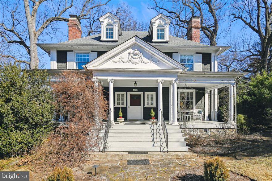 Perched atop one of Baltimore City’s most coveted lots, 209 Ridgewood Road boasts a stunning Colonial Revival home, built in 1900, on an expansive 1.93 acre double lot. Designed in the spirit of Frederick Law Olmsted Jr. and Edward Bouton’s garden suburb vision, the home’s architectural excellence is matched by its serene surroundings. The corner lot, adorned with mature trees and perennials, invites endless possibilities such as a pool, a tennis court, or a lush retreat. A wide, welcoming front porch leads into a gracious foyer, where intricate moldings, wainscoting, and a beamed ceiling set the tone for the craftsmanship found throughout. To the right, the library features built-in bookcases and a fireplace. To the left, the formal dining room, also with a fireplace, maintains its historic charm with dentil crown molding and a vintage servant’s buzzer. The kitchen blends original cabinetry with modern updates, including a Thermador gas range and a farmhouse sink. A bright breakfast nook offers the perfect spot for morning coffee, while a butler’s pantry provides additional storage and workspace. The kitchen flows seamlessly into the family room, a beautifully renovated space designed by Melville Thomas Architects. With large windows and French doors opening to a stone patio, this space is ideal for both relaxed living and entertaining. The second floor is anchored by the primary suite, where two sets of French doors frame the fireplace. A spacious walk-in closet and a luxurious ensuite bath, complete with a soaking tub and an oversized shower, create a spa-like setting. Bedroom two enjoys its own en-suite bath, while bedrooms three and four share a Jack-and-Jill bathroom. A back staircase provides additional access between floors,  connecting the home’s living spaces. On the third level, additional living spaces can accommodate a variety of needs including a fifth bedroom, a full bath, an art studio and two additional rooms that offer potential as guest quarters, a home office, or a playroom. The lower level offers a recreation room featuring exposed brick and built-in cabinetry, a separate workshop, ample storage as well as a laundry area and powder room. Outside, the expansive grounds are a true highlight, offering a park-like setting. A stone patio, framed by a knee-high garden wall, creates an inviting space for al fresco dining or entertaining. A four-car parking pad and a garden shed add to the home’s practicality. With its unparalleled setting, rich architectural details, and proximity to Blue Ribbon schools, the neighborhood library, and local dining, 209 Ridgewood Road is a one-of-a-kind opportunity to own a piece of Baltimore history.