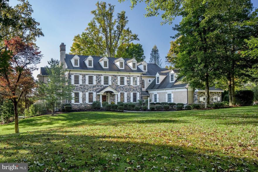 Making a grand statement on a quiet cul-de-sac in Radnor Township is this exquisite estate manor home designed by preeminent architects McIntyre Capron, custom crafted by award-winning Manchester/Hall Builders. The beautiful 1.98 level acres surrounding it is as impressive, with mature trees and breathtaking views from every vantage point. Your private drive proceeds to an oversized 4-car garage, attached to a magnificent home accented by a stunning stone facade, elegant dormers, window shutters, and a covered entry. Inside, the center hall wows with its rich wood flooring, stately main staircase, and French doors at rear bringing in natural light. Wide openings, elaborate millwork, classic detailing and refined finishes grace the interiors that are built for entertaining. Host gatherings around the gas fireplace in the spacious living room with coffered ceiling, and serve meals in the wainscoted dining room, also with elaborate moldings. The granite and stainless-steel kitchen with furniture-style cabinetry and premium Thermador & Sub-Zero appliances is a chef's dream, with a sun-drenched breakfast room for morning fare and nearby workstation for paying bills. The cook can mingle with ease thanks to a large connected open kitchen/family room layout, and French doors opening out to the rear flagstone patio. Lounge, dine, barbecue, and warm up by the outdoor fireplace in this expansive oasis overlooking picturesque gardens and fully fenced grounds. An oversized, sun-filled vaulted family room with gas fireplace is ideal for movie nights and casual get-togethers. Working from home is a pleasure in the large office with generous windows and custom built-ins. Also on this level is a handy mudroom with storage, powder room and garage access and a formal guest powder room. The 2nd floor features a sumptuous master suite offering a sitting room with gas fireplace, serene tray ceiling bedroom, fully-outfitted windowed walk-in closet, and lavish spa bath. An additional 4 bedrooms are beautifully detailed and well-proportioned, complemented by 2 lovely full baths both with double sinks. Fun and games can be had by all on the finished lower level with a game/rec space, full wet bar, exercise room, bathroom with steam shower and dry sauna, fabulous theater room with seating for 8, and plenty of storage. A carpeted family room has its own door leading out to the side patio and hot tub for the ultimate relaxation! Home includes a Generac Generator. And the location can't be beat, near top Radnor schools and amenities.