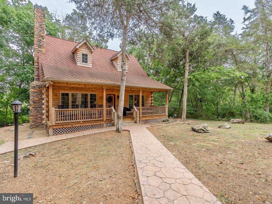 Whether you're looking for a primary residence, weekend getaway or a turn-key short term rental business, this property has it all.  Situated on almost 5 acres of pristine, deep water access to the Shenandoah River, this custom built log cabin will be sure to check off most, if not all, of your desires.  Built in 2007, this home has been a successful short term rental with incomes averaging well above $100,000 per year.  Inside you will find locally sawed log walls, hardwood floors, custom kitchen with custom made cabinetry, solid surface countertops, stone fireplace with gas logs, large primary bedroom with private bath and much more.  Outside, relax in the hot tub or enjoy a nice fire by the firepit.  Take a short walk down the gravel path to a large cleared river bottom oasis complete with it's own private dock on the water.  Home is being sold fully furnished so all you have to do is open the door and relax.  PLEASE NO DRIVE BY'S AS THIS IS AN ACTIVE SHORT TERM RENTAL.