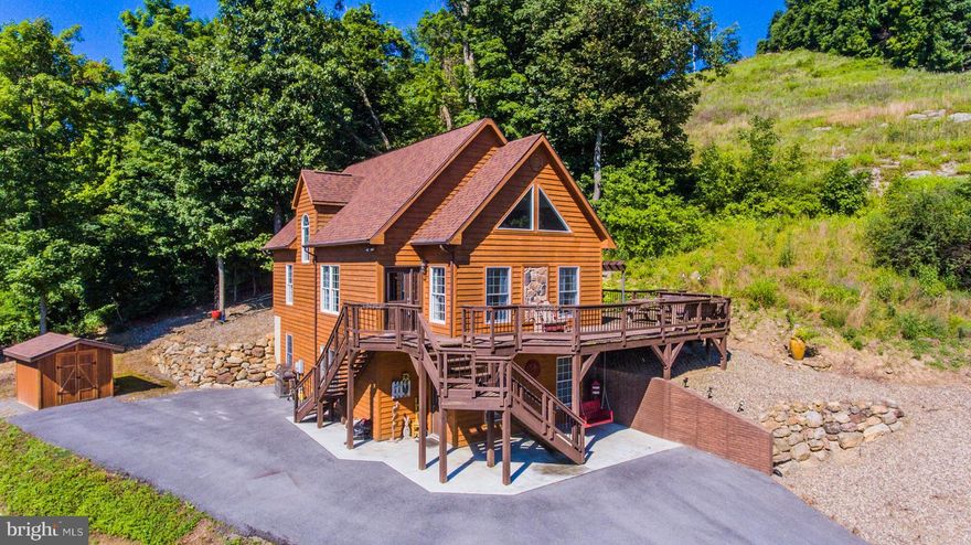 IMMACULATE CEDAR CHALET WITH AN IN-LAW SUITE AND SECOND KITCHEN. LOCATED JUST A FEW MINUTES FROM DOWNTOWN BERKELEY SPRINGS. FOUR BEDROOMS & THREE FULL BATHS, 9' CEILINGS, FIREPLACE, DUAL ZONED HEAT / AC, SOLID SURFACE KITCHEN COUNTER TOPS, MULTILEVEL DECKS & A MASTER BALCONY TO SIT ON AND TAKE IN THE VIEWS. HAVE YOUR EXTENDED FAMILY LIVE WITH YOU OR RENT OUT THE IN-LAW SUITE FOR ADDITIONAL INCOME.
