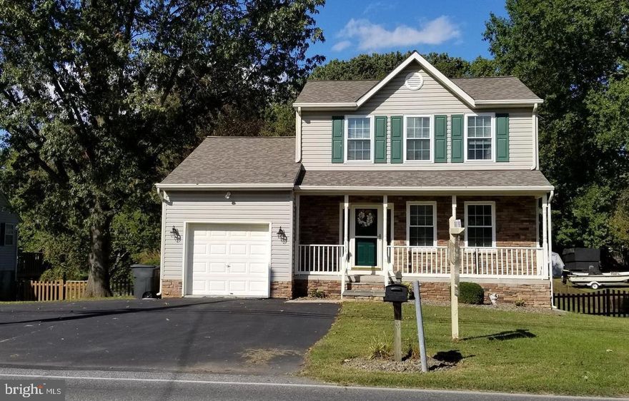 Custom Built K. Hovnanian Home on over Half Acre Lot!    This home boasts a first floor family room off kitchen, formal dining room, and first floor powder room.  Large deck measures 15 x 12.  Wide staircase to upper level with 3 bedrooms and two full baths, custom built cabinetry in main bedroom.  Lower level includes a game room, office or possible fourth bedroom, walk in closet/storage, recessed lighting.  Lots of storage!  Beautiful oak cabinetry, hardwoods, ceramic flooring,  Corian counters, and chair rail.  Beautiful stone front recently added w/recessed lighting and room full front porch.   All new appliances in 2013, new roof, windows, heating and heat pump in 2018.     Home Sweet Home!