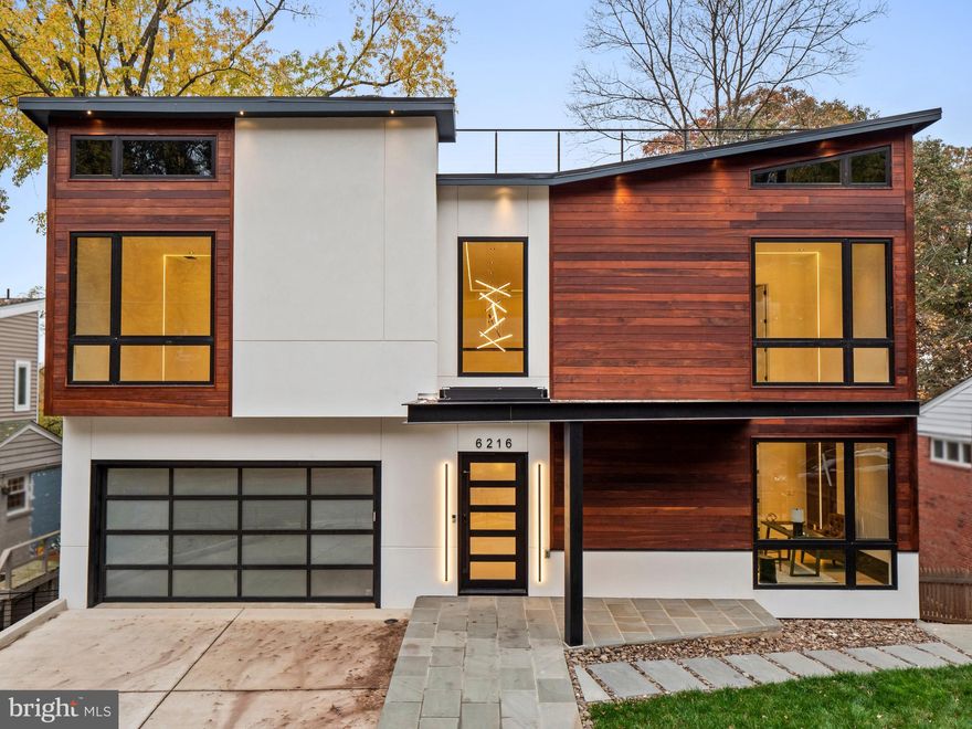 Luxurious, meticulously crafted with breathtaking Virginia and DC skyline views, this is a once-in-a-lifetime opportunity to secure a brand-new dream home in this sought-after Bethesda community! Standing proud, offering the ultimate in modern design and a life of leisure, you’ll have a rare 1800-sq ft rooftop terrace to watch spectacular sunsets or festive July 4th fireworks. A Viking remote-operated sliding gate ensures quick and convenient entry. You'll be greeted upon arrival by a handsome exterior showcasing IPE wood panel siding that blends seamlessly with the surrounding greenery. Come inside and discover neutral tones splashed across the abode's multiple levels, highlighted by strikingly chic LED lighting. Andersen windows allow ample sunlight to stream in while 8-ft-high doors and engineered European oak wood flooring make the residence feel grand. LED lighting throughout shines on wood paneling and an eye-catching staircase, the handiwork of a renowned interior designer.
An open kitchen and living room provide the ideal setting for entertaining visitors. Read or converse by the intimate fireplace while taking in scenic neighborhood vistas. All Wi-Fi ready, Thermador smart appliances in the sophisticated custom-built kitchen ensure that the avid cook can deliver hearty meals. A walk-in pantry with glass doors keeps your items visible and secure. Invite your company to sit at the 4-seater island or in the nearby chandelier-lit dining room. There's more space for them to gather in the lower-level bar, alongside which you can set up a small nook. Expansive, comfortable bedrooms are complemented by exquisite designer baths. Surpassing all is your primary suite with a bespoke walk-in closet and an ensuite that enjoys dual sinks, a soaking tub, and a glass-enclosed walk-in shower.

Whether you're a movie buff or casual watcher, you’ll savor every minute spent inside the sensational in-home movie theater with its 12-inch soundproof concrete wall and built-in theater lighting. If it’s something more outdoorsy you crave, head to the multi-level backyard with a flagstone patio for a breath of fresh air. A built-in gas line means summer cookouts can become a new tradition. A water fountain feature along the outside terrace adds a welcome touch to your oasis. Dine alfresco on the large deck or while appreciating unparalleled panoramas on the finished rooftop terrace. Other excellent perks include Pyle Bluetooth speakers, 2 Nest thermostats, a Wi-Fi-ready washer and dryer, and a Trane gas furnace. Plus, this impressive residence is only moments from the popular Smithsonian museums and monuments that line the National Mall in Washington DC. This incredible home could be all yours, so come get a glimpse to experience it all for yourself!