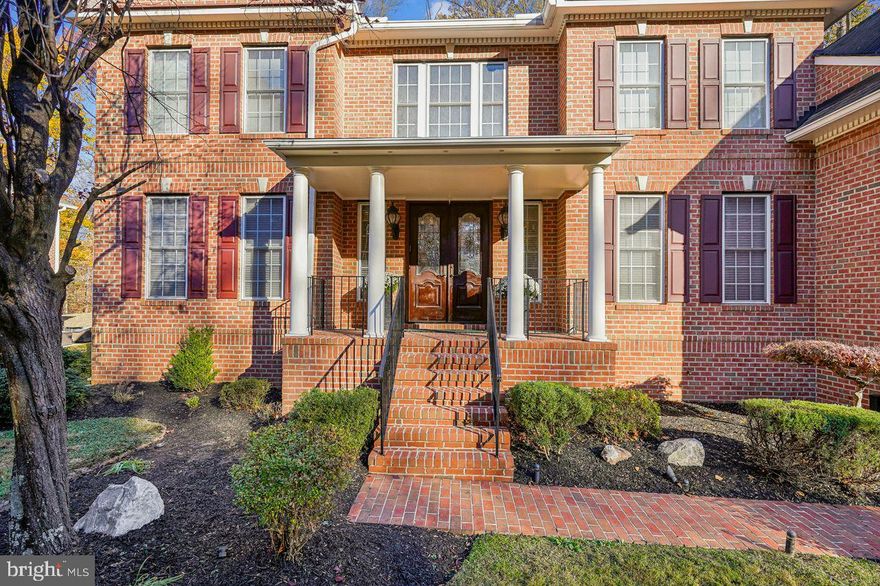 Price Improvement! Now offered at $1,895,999. Exceptional opportunity to own this stunning Custom Williamsburg  Group Estate | Former Model | Cul-De-Sac Setting 

Tucked away on a quiet cul-de-sac with ample parking for entertaining, this former model home is an exquisite custom Williamsburg Group estate sited on a premier .49-acre lot in the sought-after Heritage Walk Community. Offers 5 bedrooms, 4.5 baths, and over 9,600 sq. ft., this exceptional residence blends timeless architectural elegance with modern luxury.

A long private driveway and brick paver walkway lead to a stately front porch framed by elegant columns, creating striking curb appeal. Double entry doors open to tiled floors and a dramatic two-story foyer featuring a pair of cascading curved staircases and a secondary rear staircase. Formal living and dining rooms flank the central foyer, showcasing crown molding, chair rail, and picture-frame molding, as well as architectural doorway surrounds, hardwood floors, and generous proportions—ideal for banquet-sized entertaining.

The heart of the home is the expansive gourmet kitchen, appointed with professional appliances, gas cooking with a custom hood, granite countertops with a coordinating granite backsplash, a commanding center island with a sink, a coffee station/wet bar/butler’s pantry with an ice maker, and a walk-in pantry. Adjacent breakfast and morning rooms are filled with natural light and provide access to a private composite deck—perfect for additional gathering space.

The two-story grand family room is defined by two elegant columns, a dramatic interior overlook balcony, floor-to-ceiling windows, and a central fireplace with architectural surround. Extensive crown molding, wainscoting, and gallery-style wall space ideal for art create a grand yet inviting focal point just steps from the kitchen.

The main level also features a private study, sun-filled conservatory, piano room, access to the upper-level balcony, a convenient homeowner coat closet adjacent to the laundry room off the garage entrance, a powder room, and dual guest coat closets—thoughtfully designed for comfort and functionality.

Upstairs, the luxurious primary suite features a tray ceiling, a spacious sitting room with a beverage center and a wine cabinet, and an impressive his-and-hers spa-style bath, separated by an oversized custom-tiled glass shower with dual walk-in entries and showerheads. The suite is completed by dual vanities, soaking tub, custom cabinetry with granite countertops, and his-and-hers closets, including an oversized bonus walk-in closet designed for an extensive clothing and shoe collection.

The upper level services all four en-suite bedrooms, including the primary suite, a private guest suite with attached bath, and two additional en-suite bedrooms connected by a Jack-and-Jill bath, all featuring closet organizers. The upper level has been freshly painted and features brand-new carpeting.

The fully finished lower level is designed for entertaining and flexibility, featuring a custom kitchenette with dual sinks, a dishwasher, an ice maker, a beverage refrigerator, a wine cooler, and abundant cabinetry. Additional spaces include a large recreation room, exercise/game area, media or flex room, guest quarters, full bath, and unfinished storage.

Outdoor living includes a composite deck and rear balcony overlooking a blank-canvas backyard, offering endless possibilities to create a custom garden, outdoor living space, or future enhancements tailored to your vision.

Luxury and convenience continue with a two-car front-loading garage, gas heat, central air conditioning, and public water and sewer. Ideally located near Cabin John Park, Montgomery Mall, Pike & Rose, Strathmore, major commuter routes, and Montgomery County public and private schools, this rare offering of craftsmanship, scale, and privacy will impress the most discerning buyer.

Come home to elegance, privacy, and luxury - all at once.