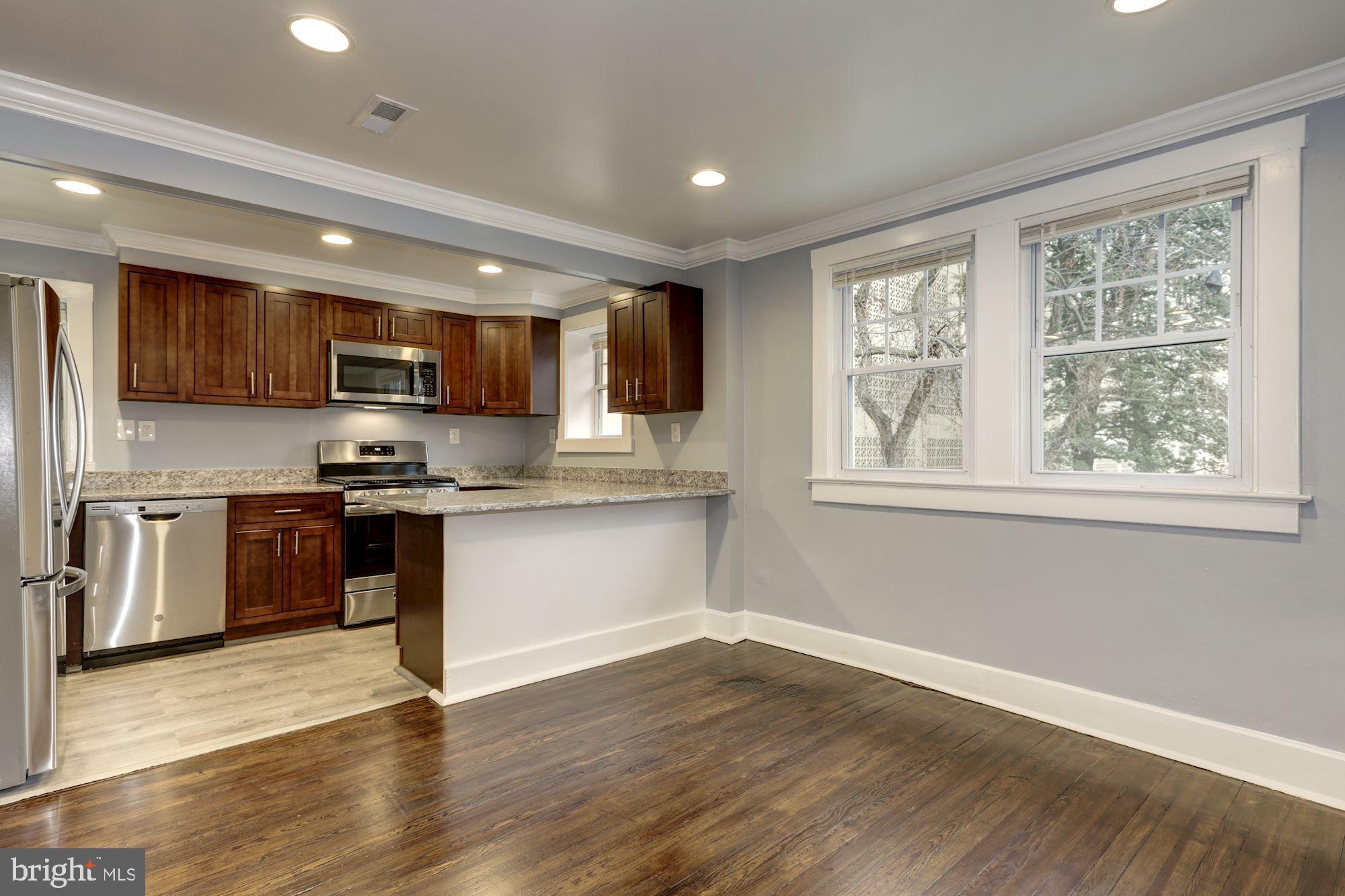 Location! Location! Location! Spacious newly renovated home in the heart of Downtown Silver Spring - across the street from Safeway, two blocks from the library, only a half-mile from the metro, blocks from AFI, The Fillmore, Downtown Silver Spring, Whole Foods, Regal Theater and countless restaurants. This featured 2nd floor 2 bedroom unit enters by way of a private entrance at the side of the home. This unit has hardwood throughout and a gorgeous updated kitchen with granite counters and stainless steel appliances. There is a washer/dryer in the unit and both bedrooms have extra deep closet space.