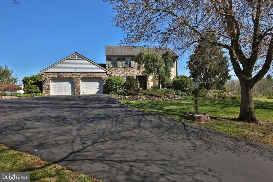 Tucked away on a private cul-de-sac in Hilltown township just outside of the quaint town of Blooming Glen, backing to farmland, sits a custom built, one of a kind, meticulously maintained & tastefully updated, 2-story colonial. As you drive down the tree-lined, dead-end street, its apparent that this neighborhood is unique. Country suburban life at its finest. From the well maintained asphalt  driveway to the landscaping & hardscaping, quality & thoughtful details are noticeable everywhere you look. As you enter the 15 panel, solid wood front door with stained glass side lights into the tiled 2-story foyer, the first noticeable detail are the matching 15 panel, beveled glass wood pocket doors leading to the living room featuring built in speakers & wood floors. Head across the foyer to the formal dining room where the wood floors continue with plenty of room for a large table to host formal gatherings. Next is the beautifully appointed custom kitchen including granite countertops, pendant & under-cabinet lighting, extra deep stainless sink, induction cooktop with commercial grade downdraft ventilator, wall oven, oversized pantry & raised breakfast bar.  Abound in natural light with spectacular views of rolling farm land as your backdrop, enjoy your informal meals in the breakfast area, just off the kitchen, with your loved ones. The 2-story great room is perhaps the best room in the house to relax after a long day. Enjoy the warmth of the propane fireplace insert and the beauty of the cut stone chimney on a cold winter night. The oversized Pella casement windows and slider feature matching palladian windows for extra natural light, twin skylights, recessed lighting and ceiling fan cap off this marvelous space. The first floor master suite is everything you could want featuring vaulted ceilings,  floor to ceiling cut stone fireplace with propane insert, oversized Pella casement windows with palladians above, walk in closet and plenty of space to relax and recharge.  The master bathroom was fully renovated in 2021 featuring vaulted ceilings, recessed lighting, a massive, curb-less shower with rainfall head & wand, beautiful travertine tile throughout and one of the most gorgeous pieces of matching granite on the double bowl custom cherry wood vanity and two benches within the shower. Not only are there Grohe fixtures, Toto toilets and radiant in-floor heat in the master, but throughout the entire house. The laundry room with wash sink is just off the master suite as is the the oversized two car garage with industrial epoxy coated floors, built in shelving and workbench. The powder room has also been tastefully updated with granite topped cherry wood vanity, Toto toilet and Grohe faucet. Head out the Pella slider and take in the  panorama views from the Timbertech deck. Spend some time taking in all the details such as the the hard piped propane BBQ line, ornate landscaping, meticulously maintained lawn,  raised box gardens, & the 4 inch thick concrete chimney caps sitting atop the twin cut stone chimneys. The second floor features a catwalk bisecting the foyer and great room, three generously sized rooms with equally generous closets and a full bathroom with tub/shower combo.  The poured concrete basement is overbuilt in every way and a sight to be seen. With 8.5 foot high ceilings featuring a brand new boiler, piping & zone valves, newer water softener system, radon system and gravity french drain system with no need for a sump pump. This space could be so many things including: gym, hobby workshop, play area, theater room or a ton of storage. In addition to radiant heat, there are 2 zone Lennox central air conditioning systems installed in 2019.  The stucco was fully remediated in 2020. Exterior trim, facia, soffits, gutters and downspouts were replaced in 2024. With PUBLIC WATER & SEWER, this house offers the best of the country suburban life. Minutes to 113, 313, 309, restaurants, shopping & country stores. Welcome home!