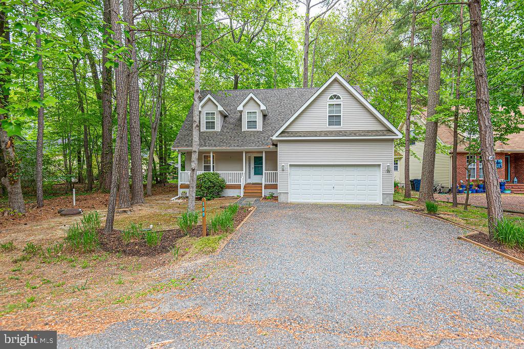 Price adjustment! Beautiful Turn-Key Contemporary home with golf course frontage comes fully furnished and with a new roof, refrigerator , washer, dryer & encapsulated crawl space. The two story great room has a corner gas fireplace and sliding door access to the large deck. Hardwood flooring highlights the dining and kitchen areas, featuring a breakfast bar and walk- in pantry. Three spacious bedrooms plus an extra bonus room promises room for everyone! Wood stained six panel doors add a touch of elegance, as does the second level “bridge” walkway overlooking the living area. A utility sink and Central Vacuum add cleaning ease. Top it off with a large screened porch, the perfect place for eating crabs or reading a book!