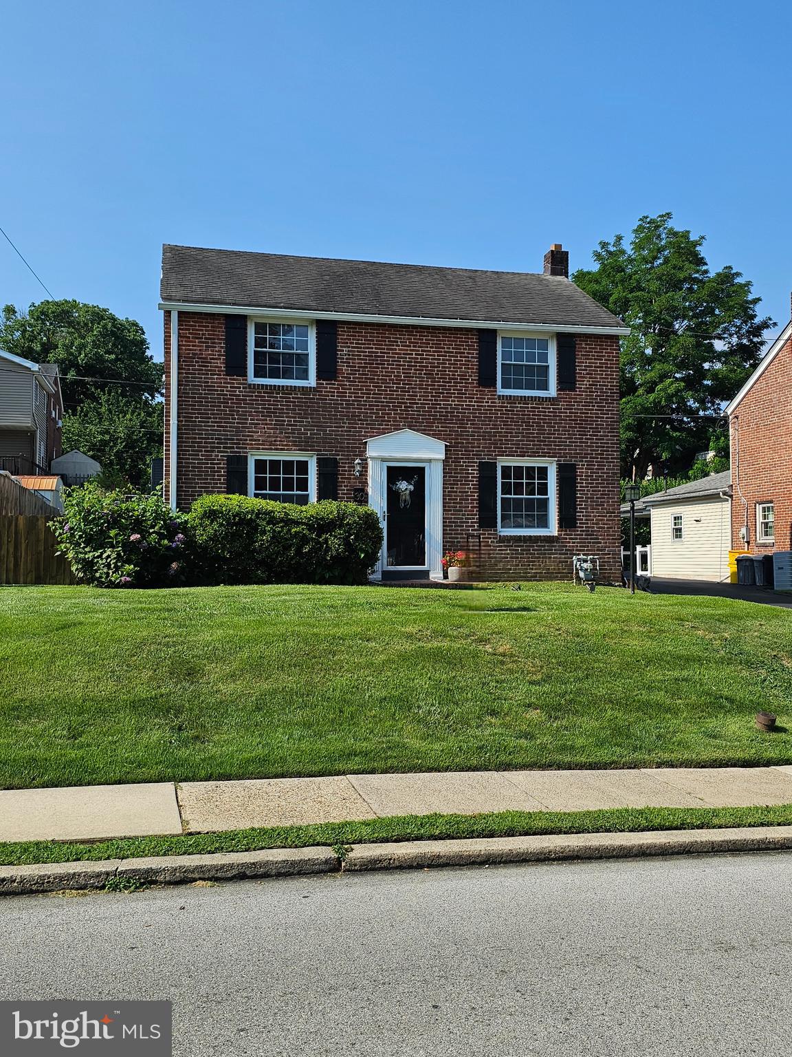 Welcome to 30 Wayne Avenue, a beautifully maintained brick Colonial nestled in Springfield’s sought-after Scenic Hills neighborhood. This inviting 3-bedroom, 1.5-bath home showcases original hardwood floors, a sunlit living room with oversized windows, a dining area, and a tastefully updated kitchen featuring granite countertops, stainless steel appliances—including a new refrigerator (2024) and dishwasher (2023)—and a center island with bar seating. Upstairs, you'll find three bedrooms and a full bath. Recent upgrades include a newer HVAC system (2017), water heater (2019), and fresh interior paint and French Drain installed and radon system. Step outside to enjoy the covered rear patio and fenced backyard—perfect for relaxing or entertaining. With a shared driveway, excellent location in the Springfield School District, and easy access to shopping, dining, public transportation, and major roadways, this move-in-ready home offers comfort, convenience, and timeless charm.
